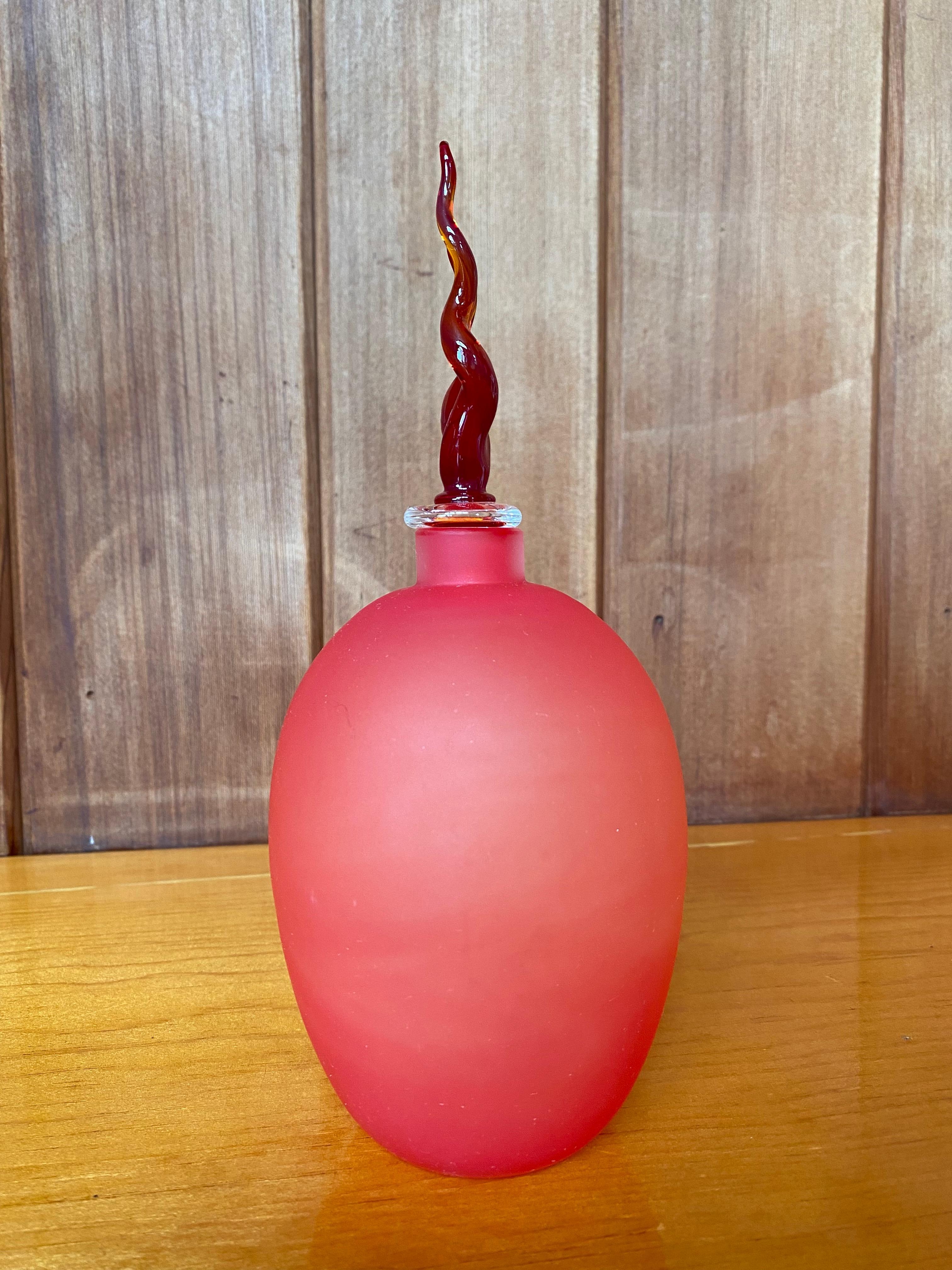Red murano glass bottle by LIP Manifattura del Vetro designed by Marcello Furlan, 1989.
Natural occurrence of color variation in marbling from red, orange and peach.
Sticker still remains.
Small marking near sticker; has not been professionally