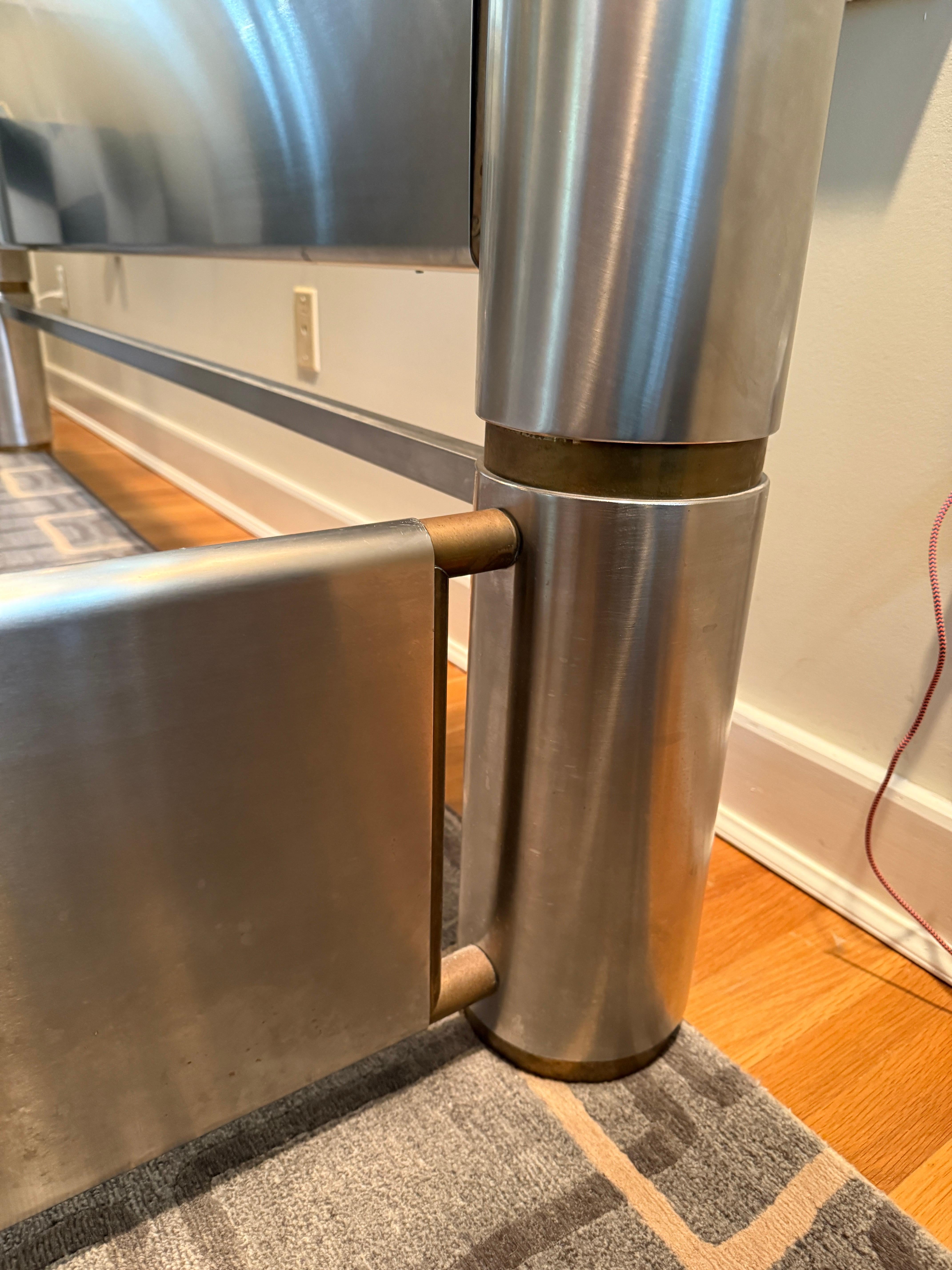 Brushed stainless steel frame with brass details throughout, this one-of-a-kind sculptural King size bed is accentuated with brass orbs on each corner (7 inches in diameter each). Heavy and well executed, this incredible bed was designed by Marcello