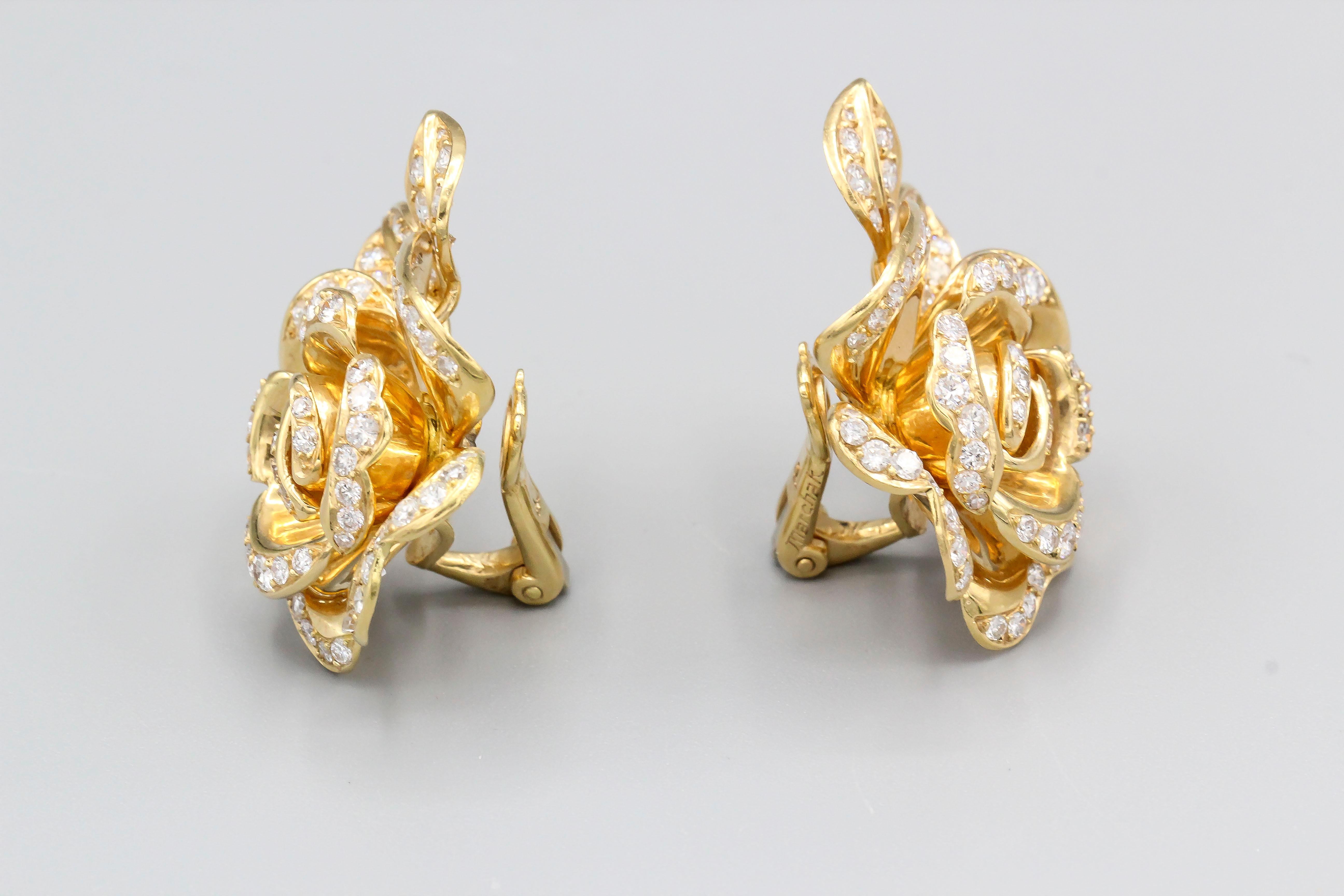 Fine pair od diamond encrusted 18k yellow gold earrings by Marchak, circa 1960s.  They feature a rose-like design with two small leaves.  Approx. 1.5 