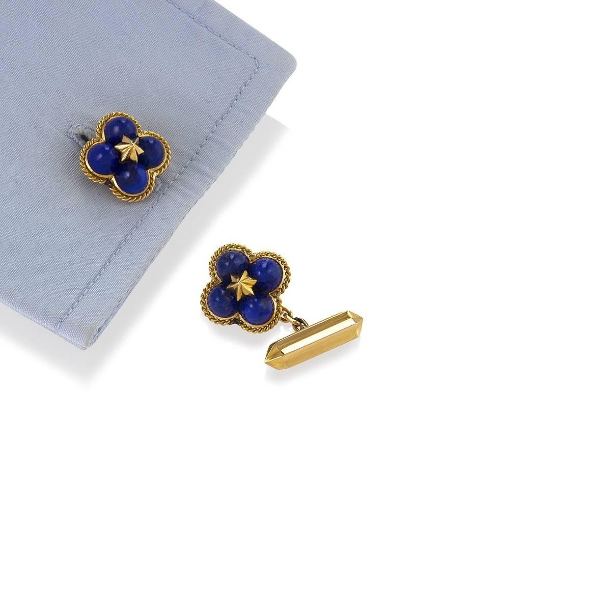 A pair of French Mid-20th Century 18 karat gold cuff links with lapis lazuli by Marchak. The clover-shaped cuff links have 8 sugar loaf lapis lazuli stones. Each cuff link is designed with 4 lapis lazuli cabochons surrounding a center gold star with