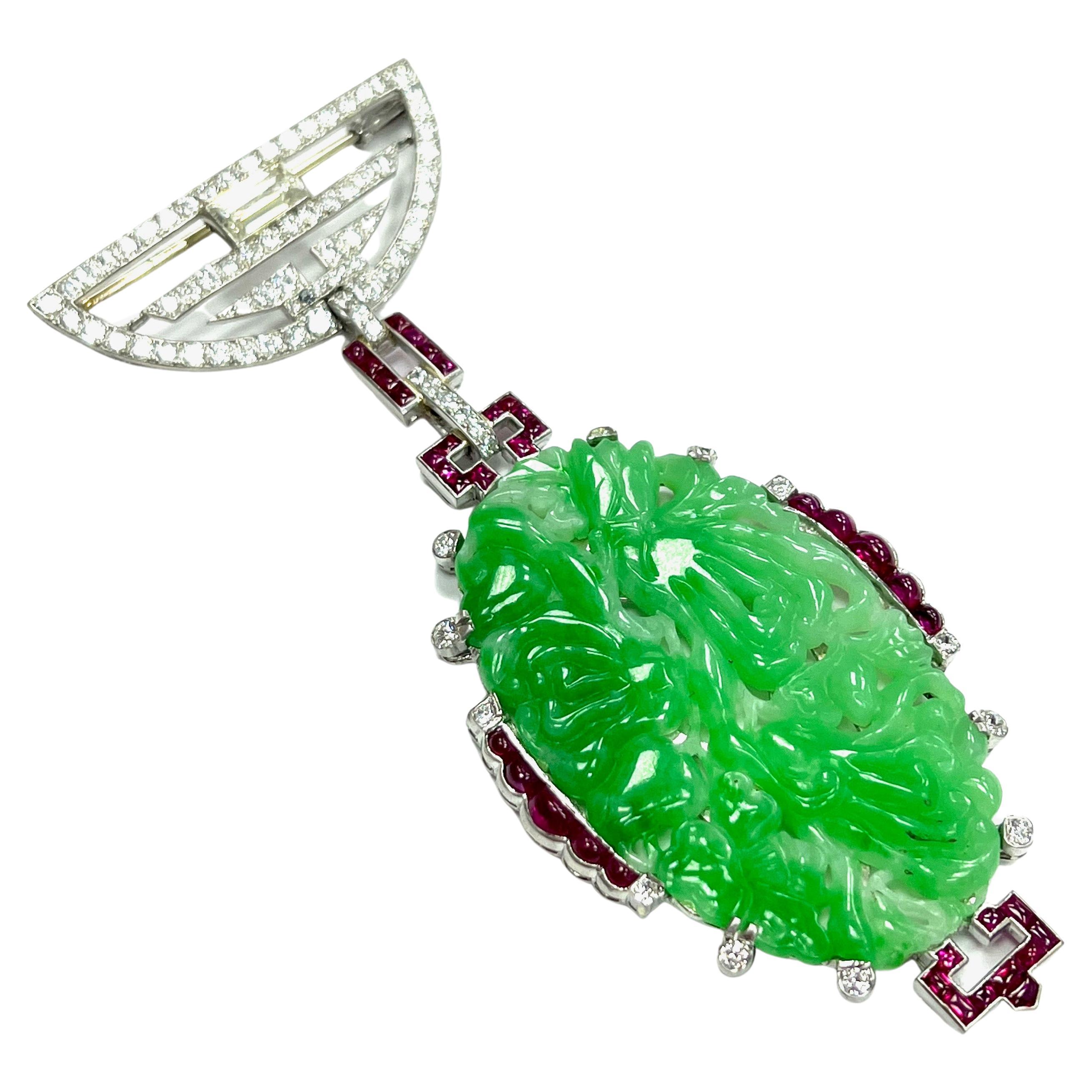 Marchak Paris Large Carved Jade Diamond Ruby Brooch

Beautiful art deco large carved jade (31 x 51.5 mm) with one main emerald-cut diamond of 1.25 carats; smaller diamonds weigh a total of approximately 2.5 carats; and cabochon and square-cut