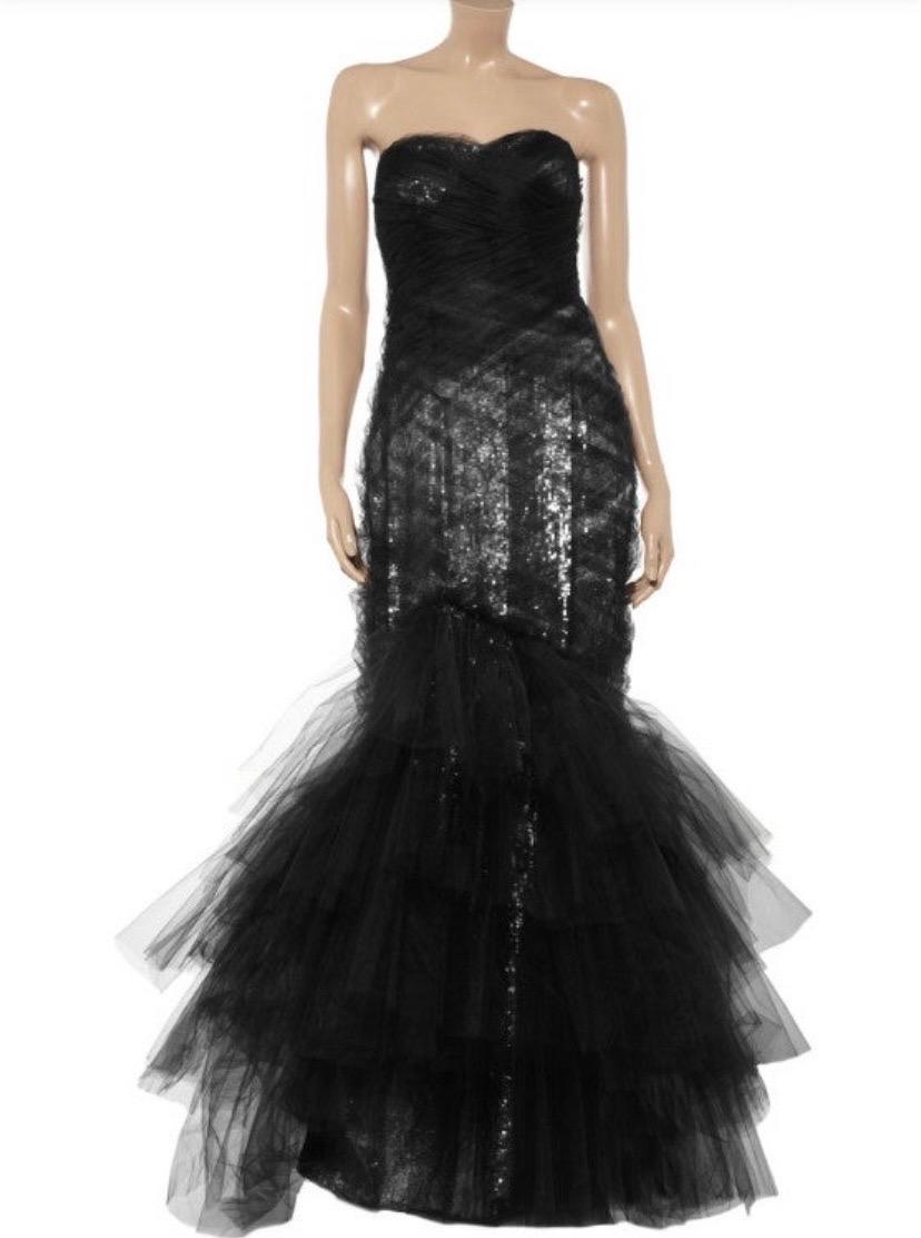 Black tie style is all about statement glamour, so make an entrance to remember in this sensational Marchesa gown. 
Size: 10 ( runs smaller, please check measurements).
Lashings of jet-black tulle and showers of silver sequins combine to stunning