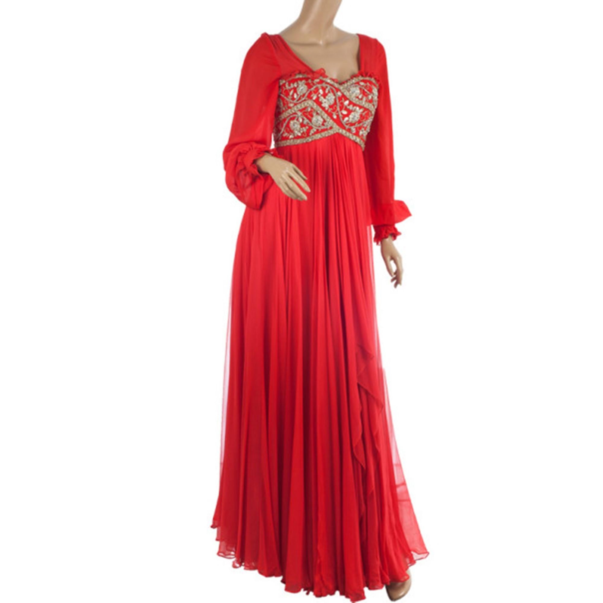 Make an unforgettable entrance at your next black-tie event in this Marchesa Embellished Empire Waist Gown. It features a sweetheart neckline, long sleeves and crystal and stone beaded bust, which is supported with structured and boned inner bodice.
