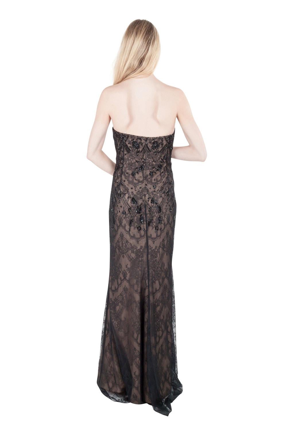 Breathtaking in black, this Marchesa creation is tailored from a fabric blend and is adorned with a lace overlay texture all over. The strapless dress has beautiful embellishments flaunted at the front and back. Opt for smokey eyes, side-swept hair
