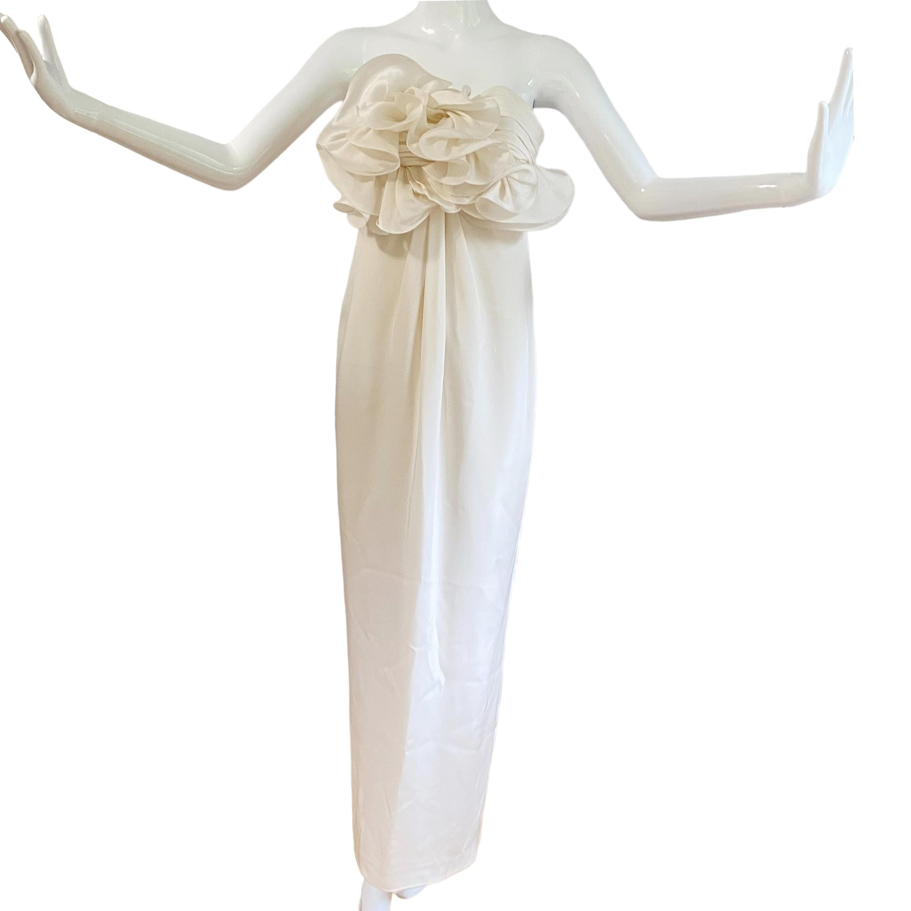 Beautiful, never used.
Lots of couture details: boned, shirring, pleats, sculptured flower, double zippers... etc.
Center back slit.
 
No fabric tag. Unsure if it's made of silk or not.
It'd fit the mannequin but since she's a bit 'wooden' (sorry