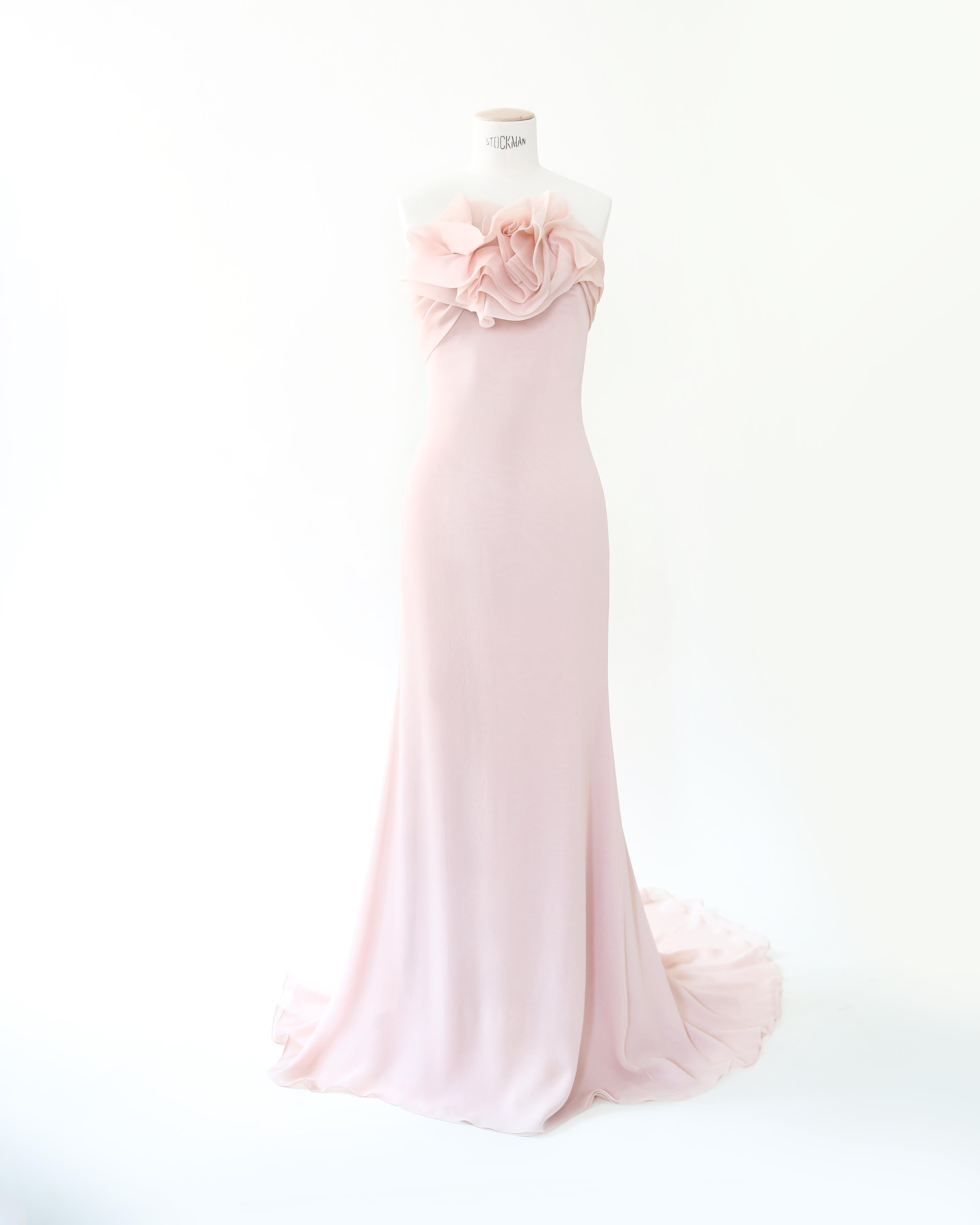 LOVE LALI VINTAGE

A incredibly dreamy dress by Marchesa in soft petal pink
Strapless cut with an inner boned corset that zips up separately inside the dress
Composed of four layers of silk with the most beautiful applique to the bust, akin to the