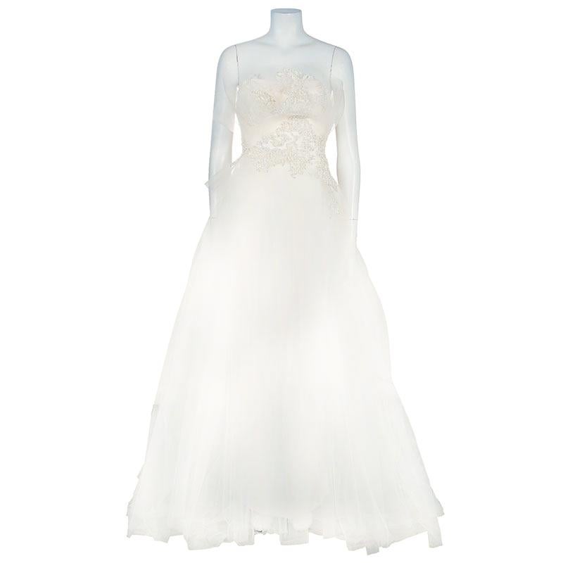 With the embroidery and exquisite detailing this ethereal floor-sweeping wedding dress comes fro the house of Marchesa. The strapless bodice is accentuated with soft ruffle detail and the ballgown is designed with tulle. A perfect dress to dress you