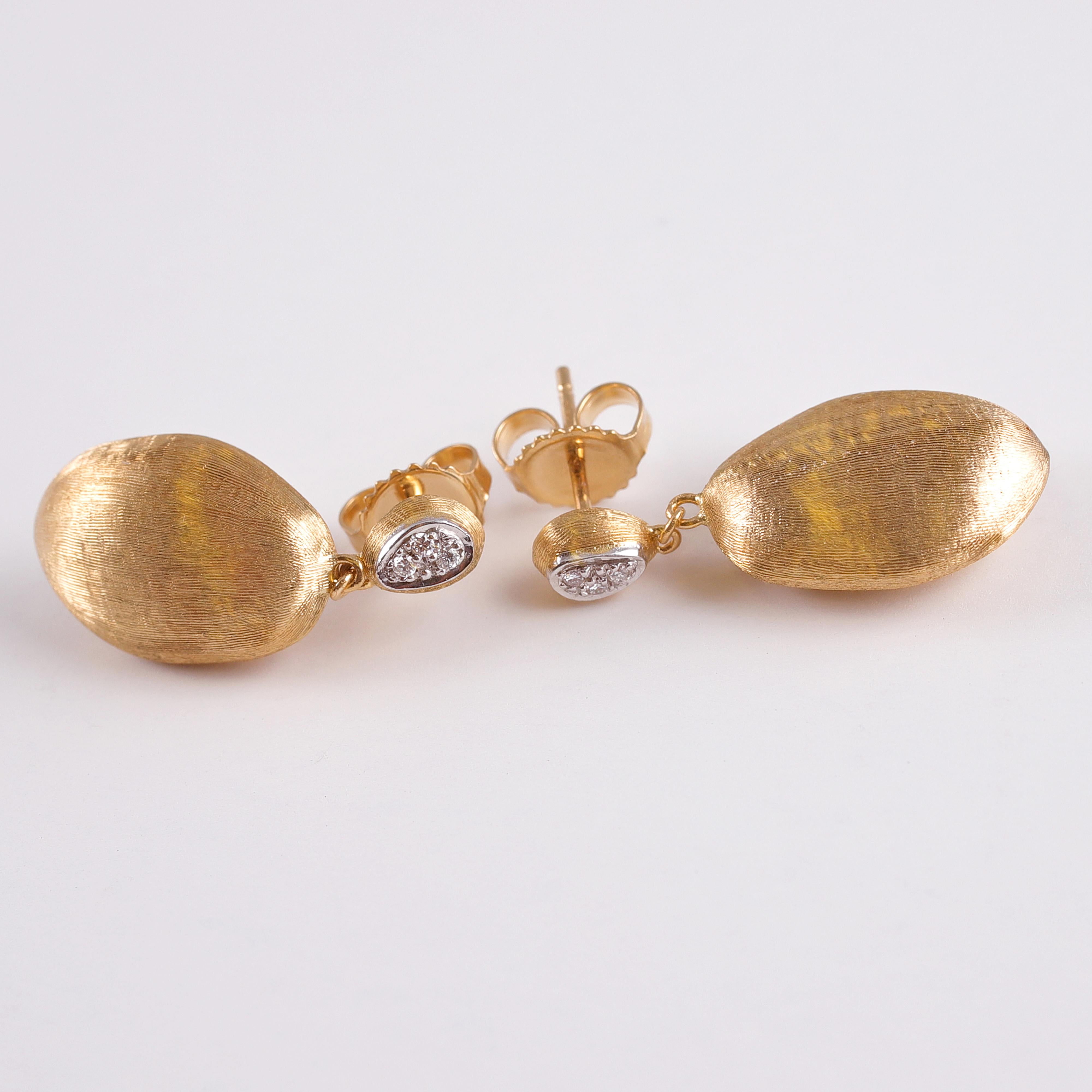 Everyday casual - or a special evening, these earrings will complete your look!  In textured 18 karat yellow gold, they are secured with standard friction backs and support twelve bead-set, accent diamonds.