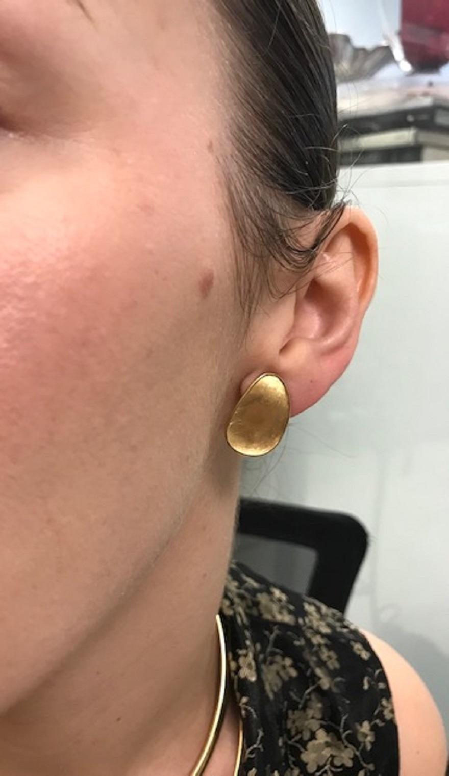 An amazing pair of Marco Bicego 18k gold clip-on earrings. Being crafted from brushed gold, they magnificently reflect the light and look extremely appealing on the ear. Due to its slightly irregular, organic shape the earrings resemble two