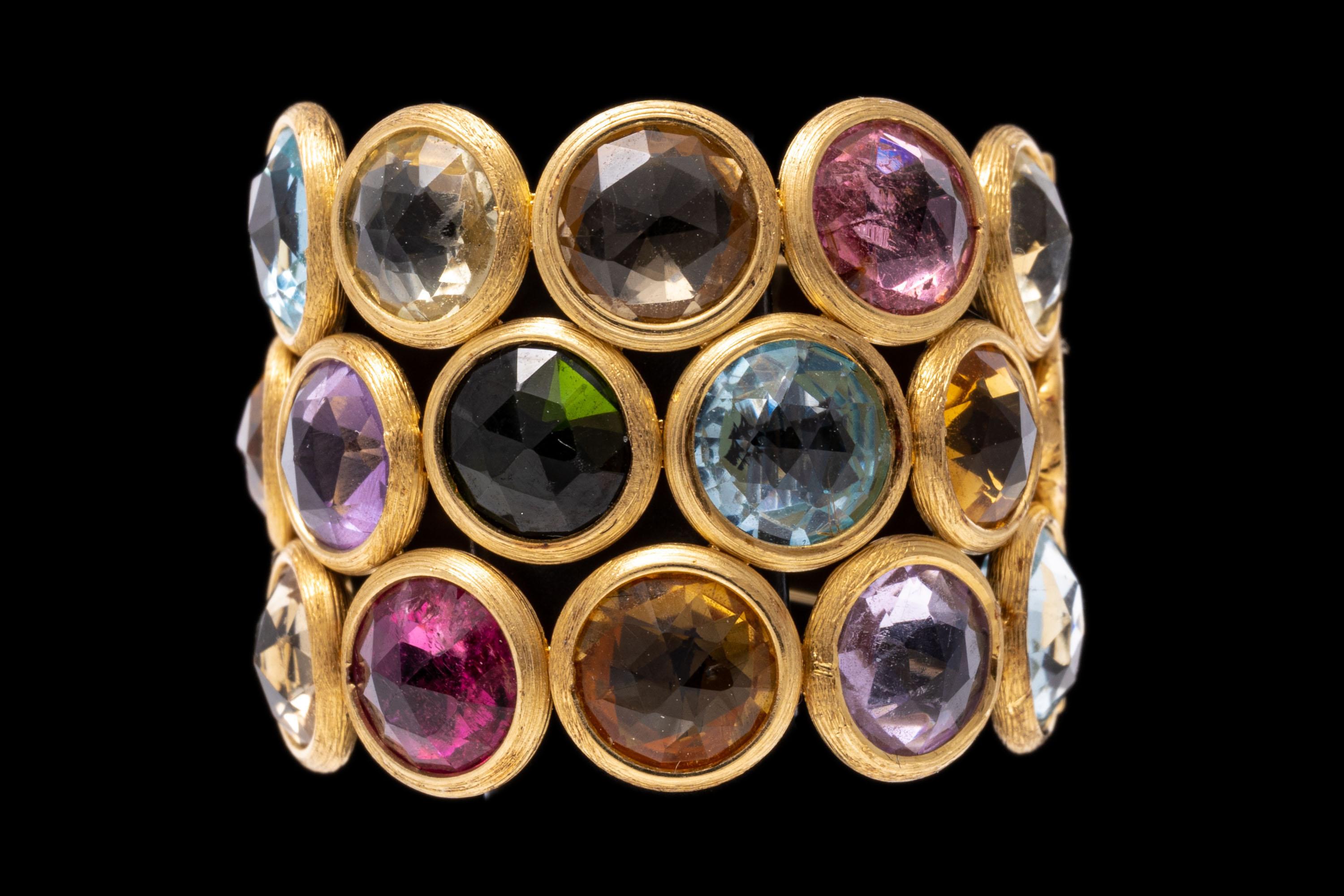 This stunning, colorful ring by Marco Bicego features three rows of candy colored, round checkerboard faceted gemstones displayed across the top, incuding: a medium green tourmaline, approximately 0.45 CTS; seven light and medium yellow color