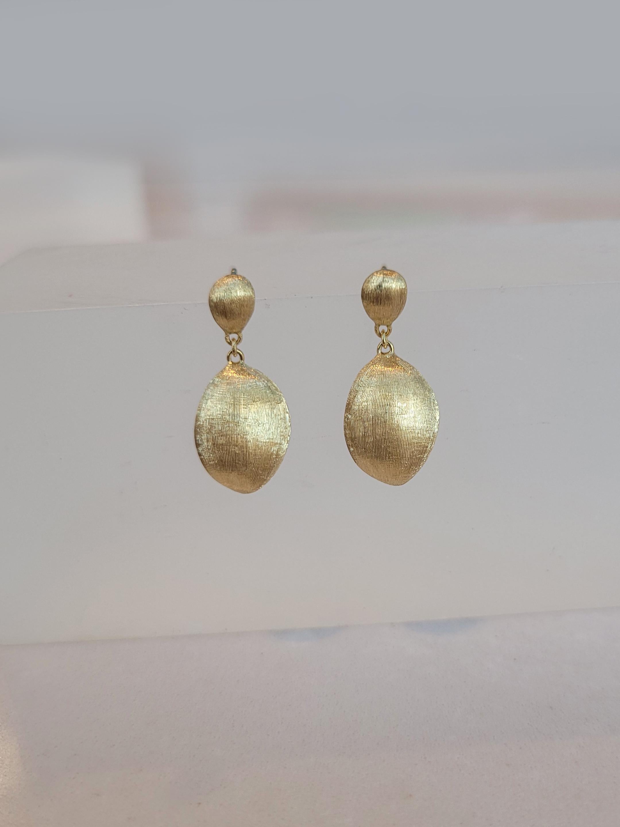 18K yellow gold earrings featuring Marco Bicego's signature hand-engraved finished. Posts and friction back closures.