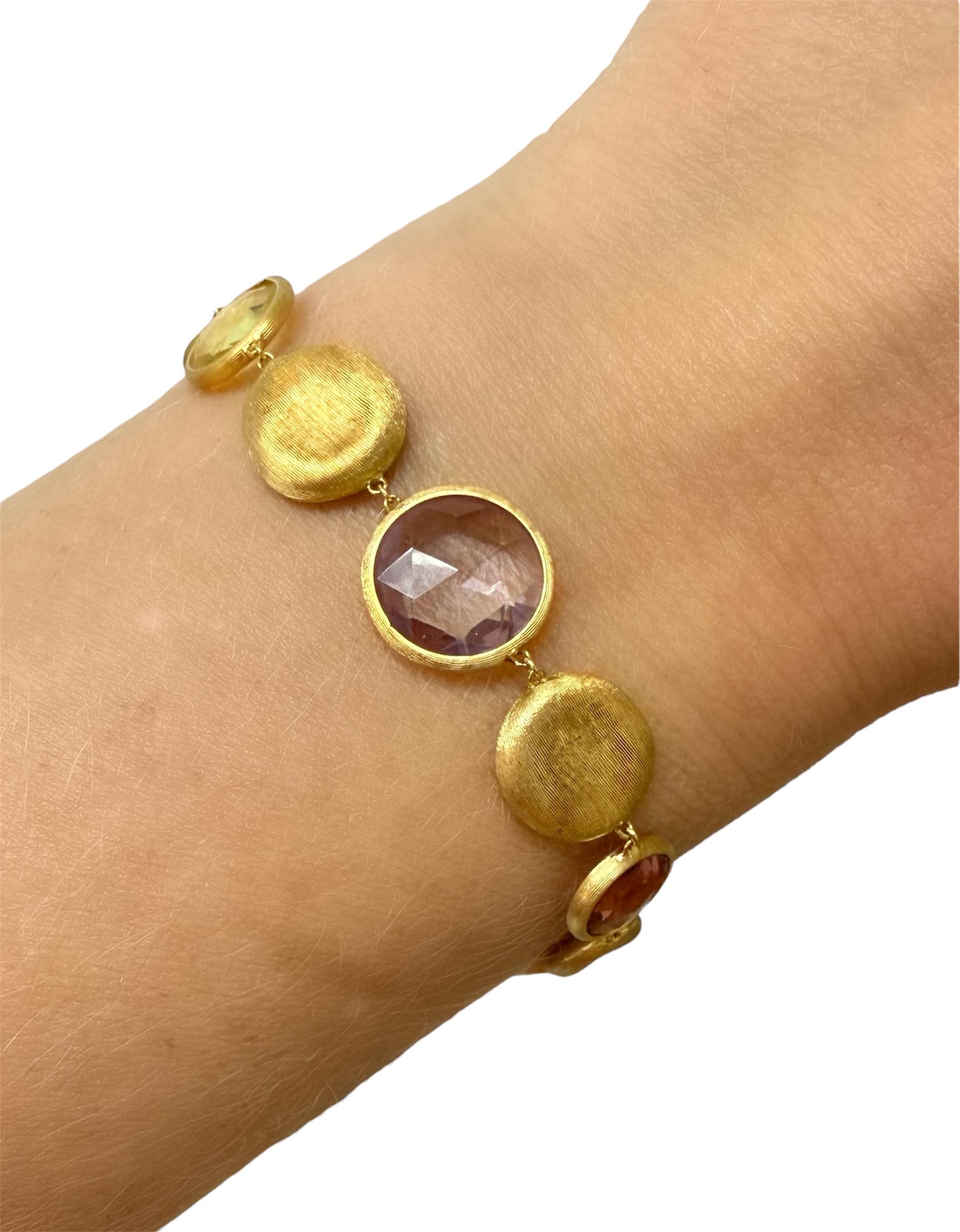 This gorgeous bracelet by Italian designer Marco Bicego from their Jaipur collection, contains hand engraved round stations interspersed with rose cut gemstones, elegantly bezel set into hand engraved ancient Florentine finish.

Measurements: 7 1/4