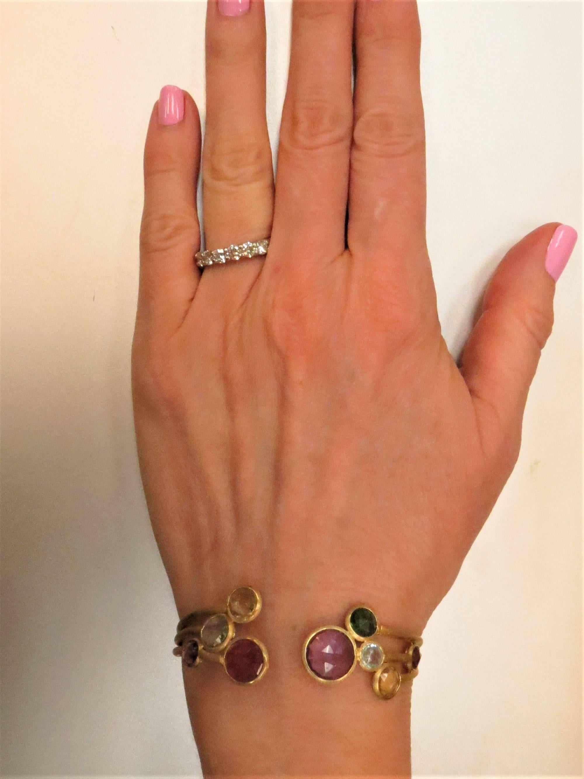 Marco Bicego, brand new, never worn, 18K yellow gold hinged bracelet bezel set with round faceted amethyst, blue topaz, tourmaline, and citrine.
Last retail $4000