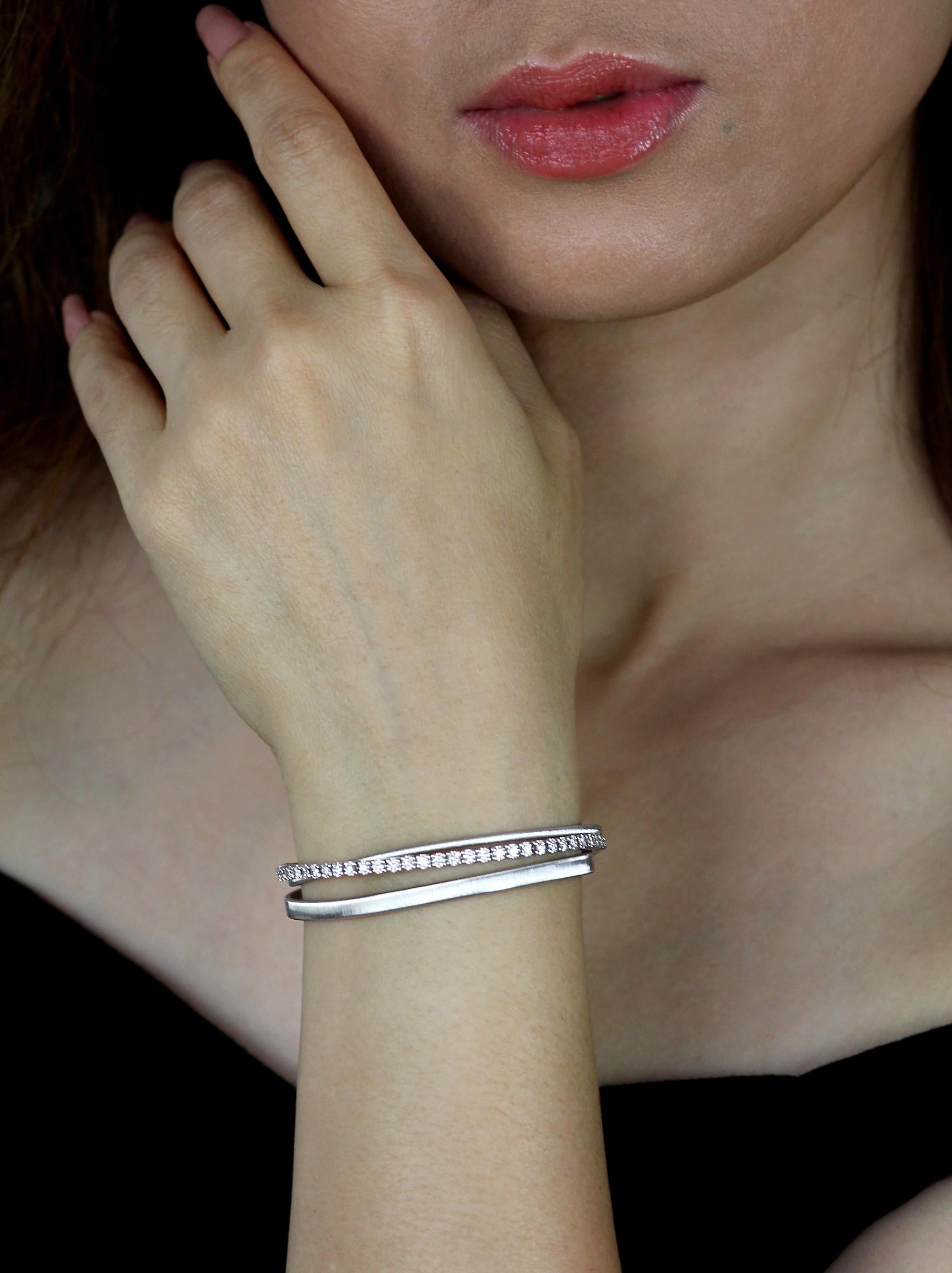 There strand bracelet by Marco Bicego, set with round brilliant cut diamonds in 18 karat white gold. 
