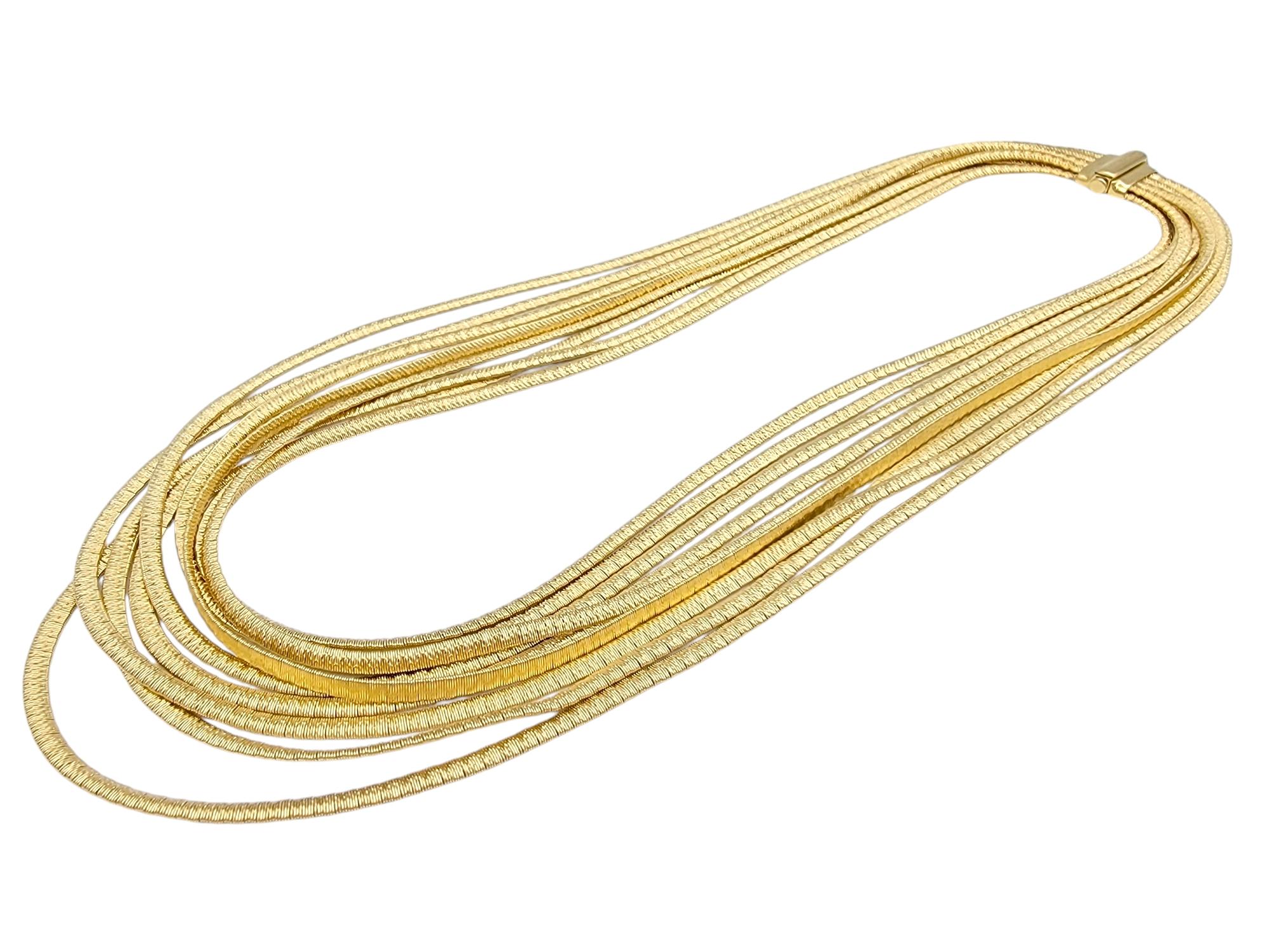 Wrap yourself in the luxurious beauty of the Marco Bicego Cairo 9- Strand necklace, a masterpiece of Italian craftsmanship. Made from rich 18 karat yellow gold, this striking necklace features nine delicate serpentine strands that gracefully coil
