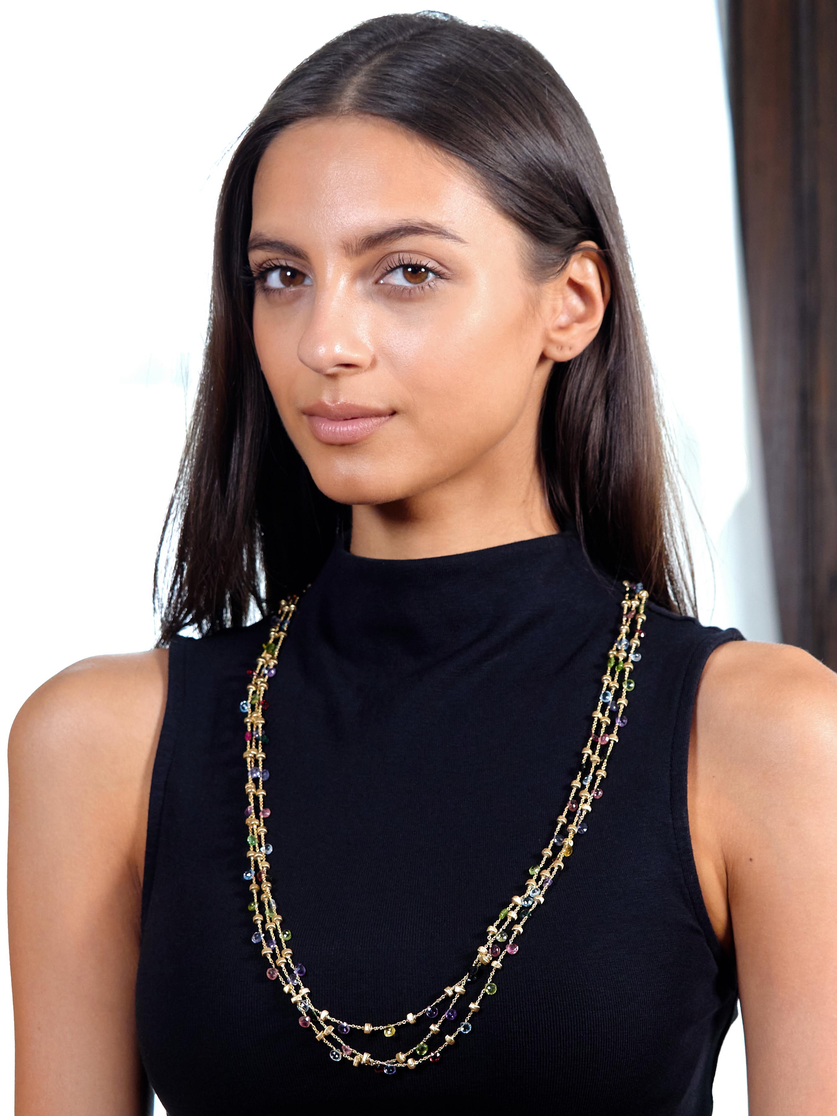 Collar necklace is comprised of three tiered strands of cable link chain with brushed gold and multi-gem beads
Gemstones are pink tourmaline, amethyst, aquamarine, citrine, green tourmaline, blue topaz, and peridot
Transparent medium pink, purple,