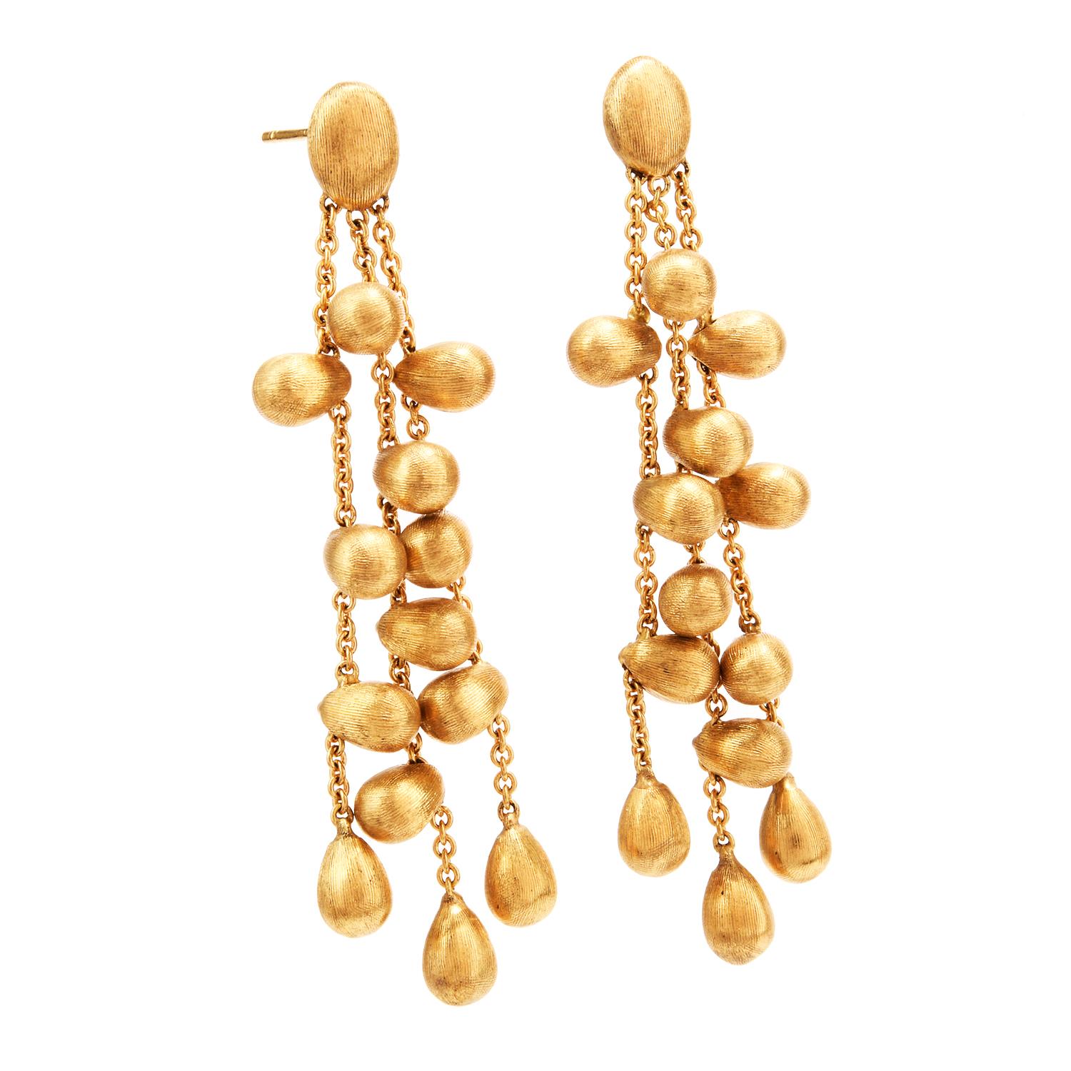 Designer Marco Bicego  was inspired by Drops of Gold with these 18K Chandelier Earrings.

3 strands of cable chain feature Satin finished drops of gold throughout.  The drops measure on average appx. 4.5 x 6.0mm.

Measuring appx. 2 Inches in length,