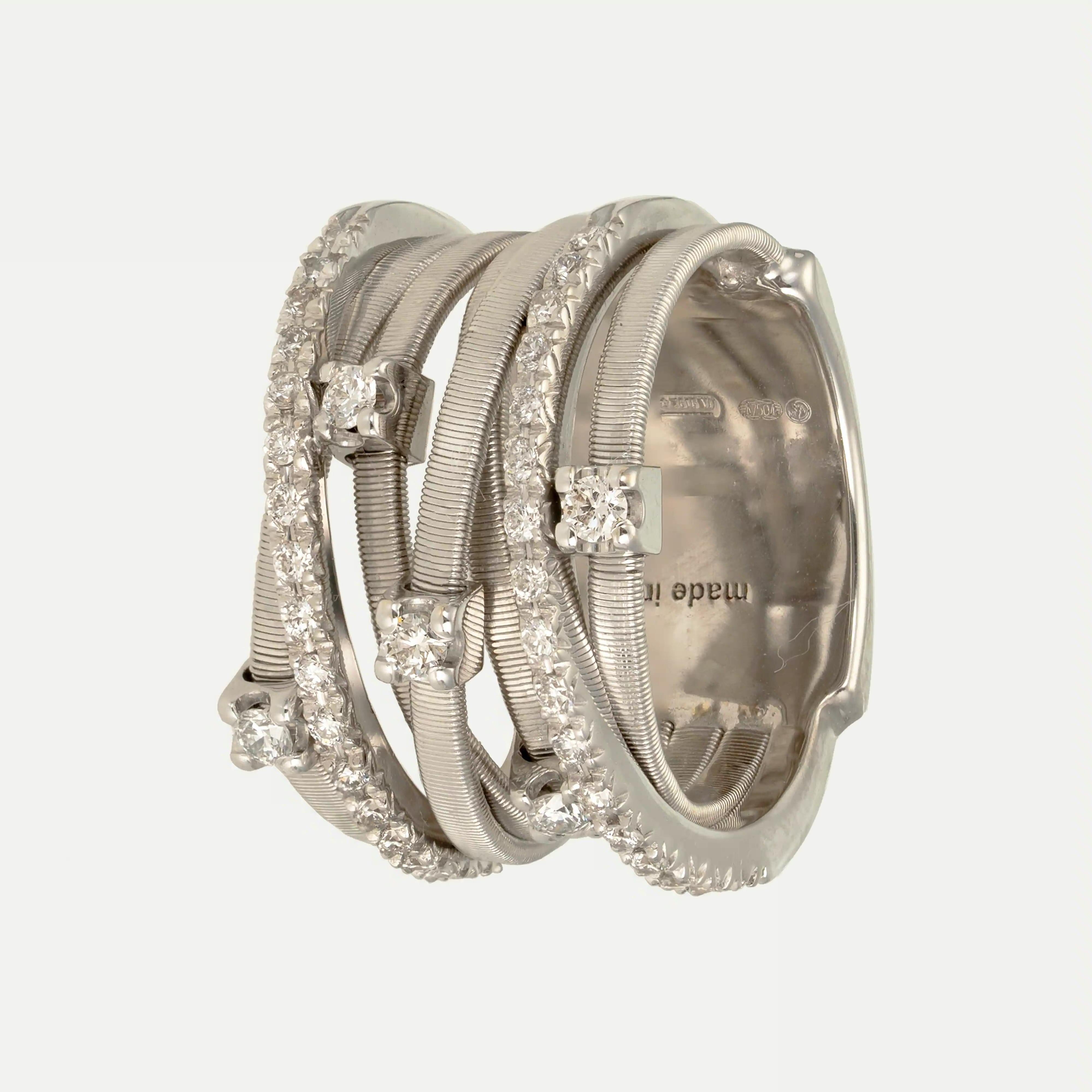 
From the italian Brand, this 18kt – 750‰ Marco Bicego’s white gold ring from the Goa Collectionby is inspirei Bay the ethereal white coastlines of the Indian Ocean. A criss-cross of flattened white gold strands, set with 39 brilliant-cut diamonds