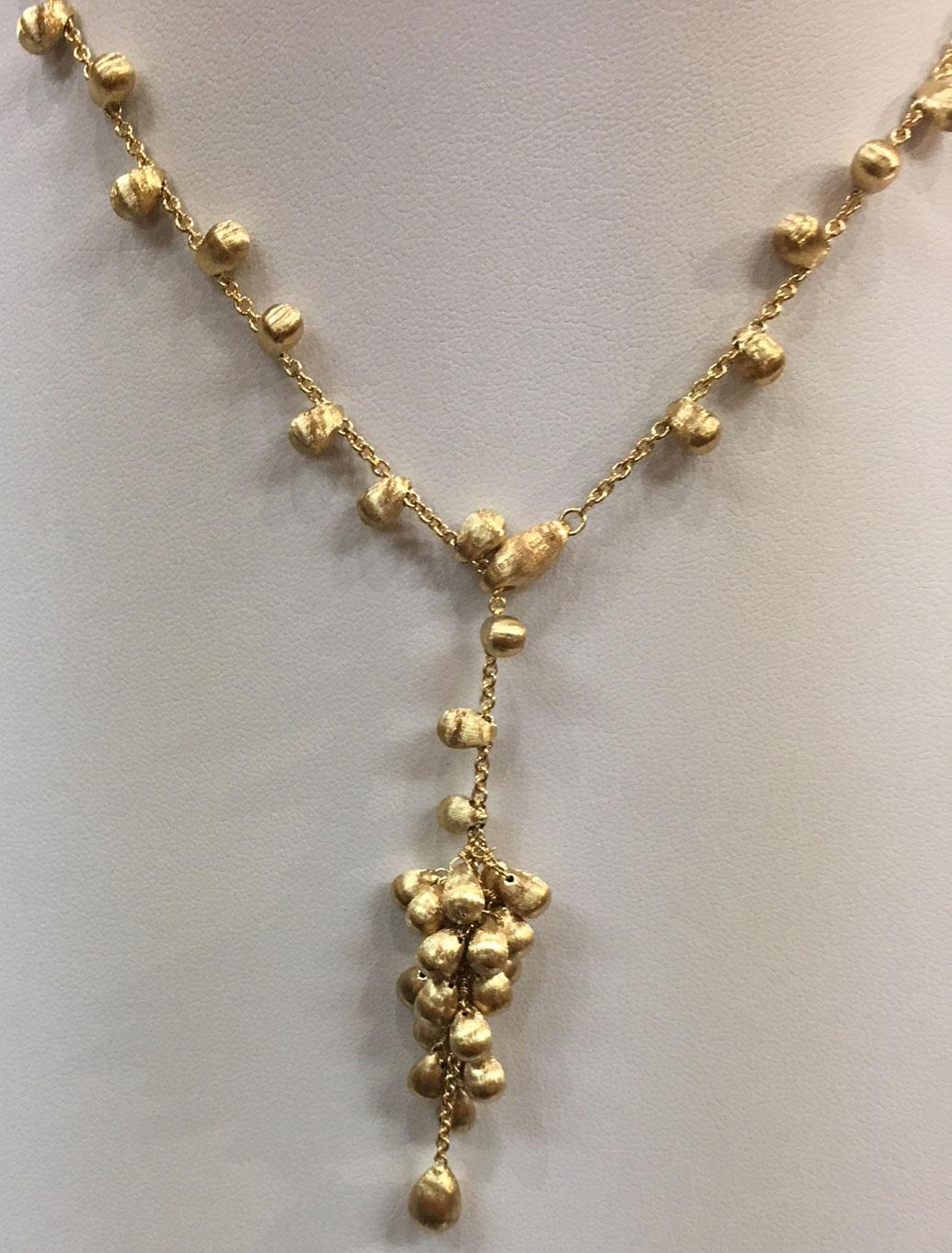 Beautiful Marco Bicego necklace features gold ‘nugget’ beads, crafted in 18-karat yellow held by a hinged clasp. Approx. 16” long, not including the cluster dangle. Necklace is signed and numbered. 
Marco Bicego: 