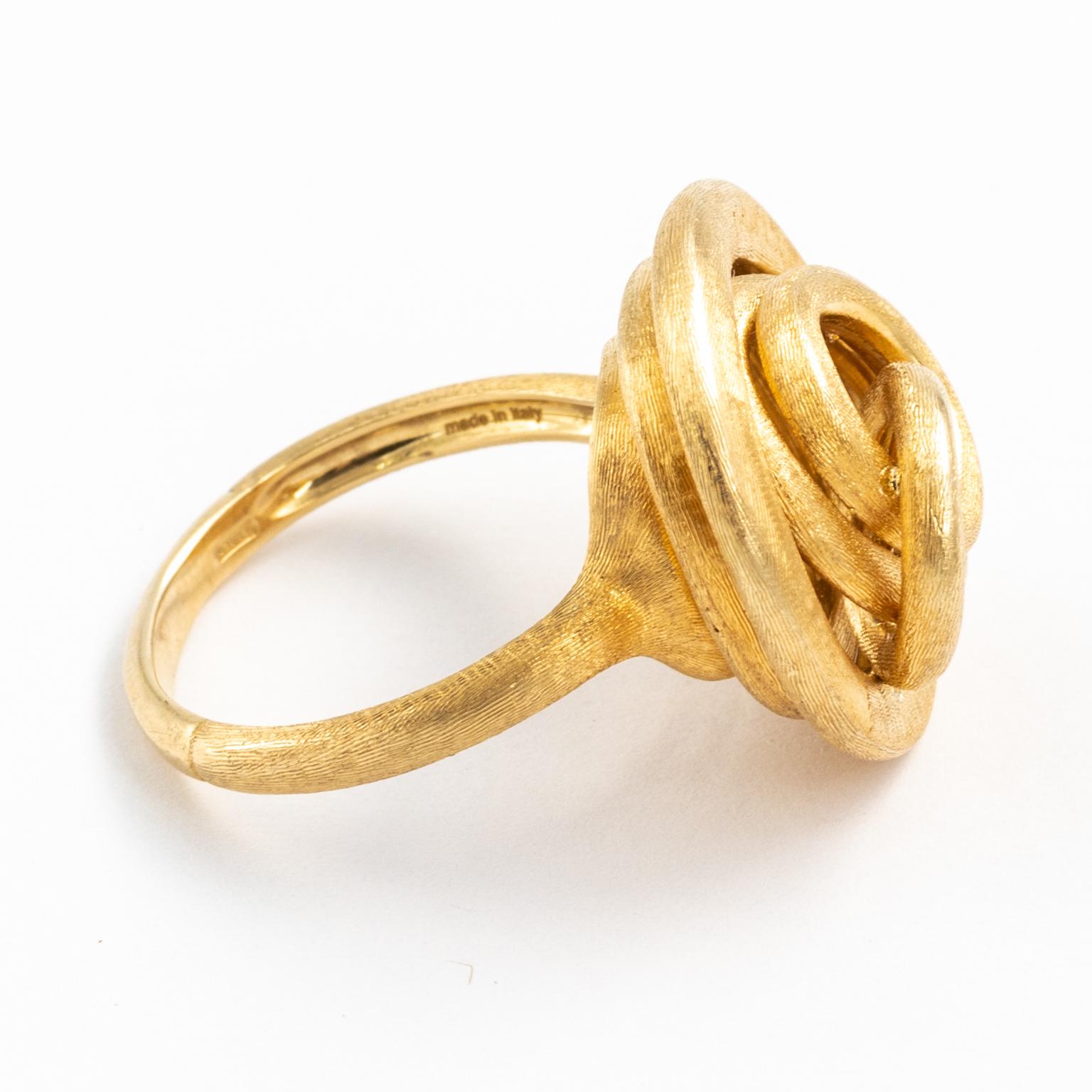With golden grace, Marco Bicego presents this lovely ring in the Jaipur Link collection. Set in lush 18kt yellow gold, circles of various sizes are stacked and interlinked to form the contemporary design of this gorgeous piece. The silky effect of