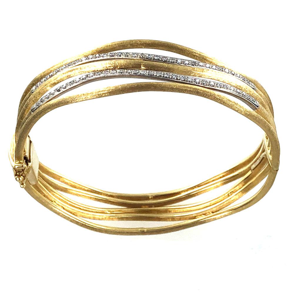 Marco Bicego Jaipur Five Row Diamond Bangle Bracelet fashioned in satin finished 18k yellow gold. The bangle features two rows of near colorless round brilliant cut diamonds (approximately 1.00 carat total weight). The oval shape bangle measures