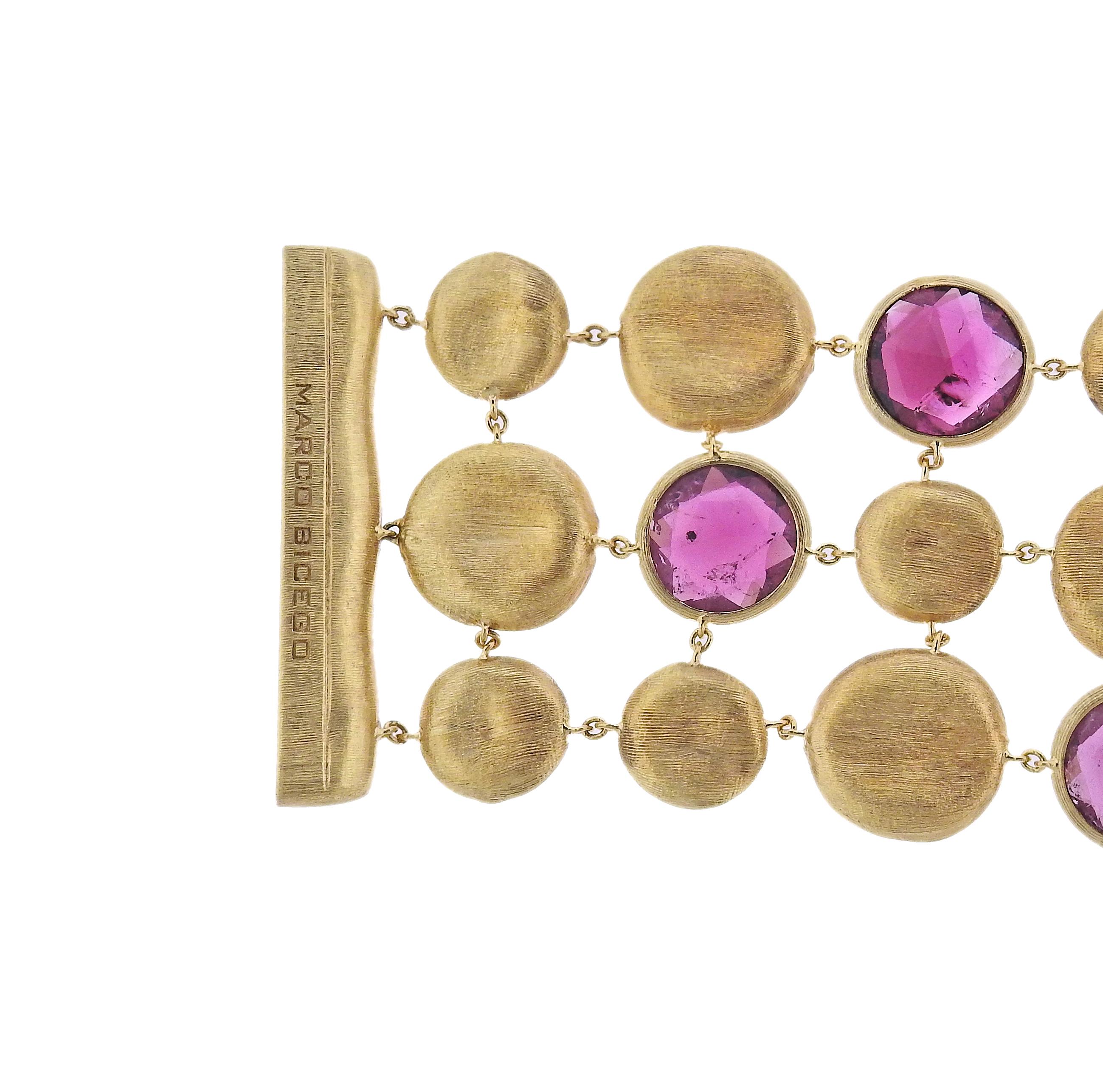 Marco Bicego Jaipur collection 18K yellow gold multi strand link bracelet set with spessartite garnets. Bracelet is 7
