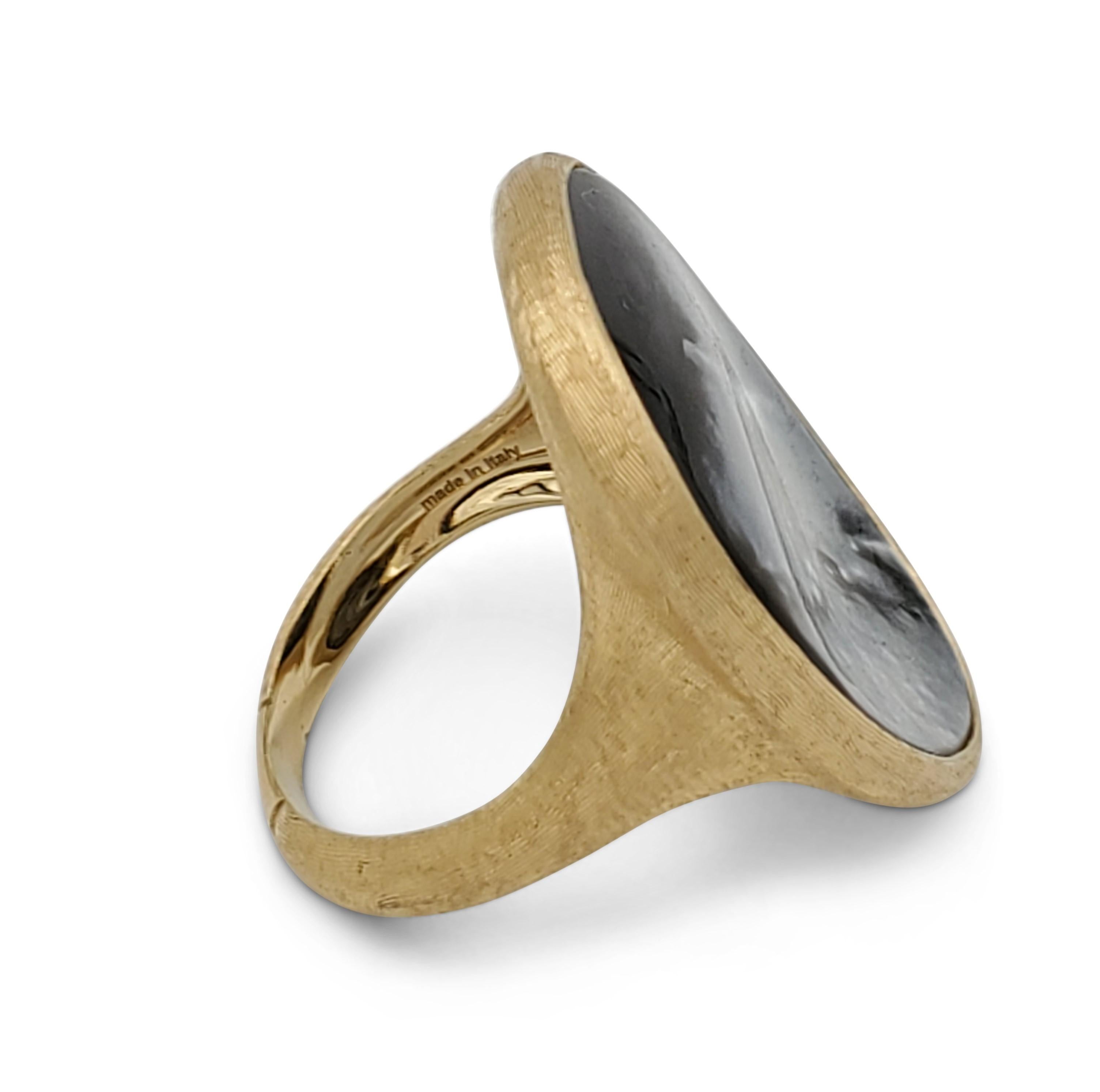 A handcrafted 18 karat yellow gold ring centering on a black mother of pearl stone and inspired by the lunaria flower. Made in Itlay. Signed Marco Bicego and marked 18K, serial no. 2616. Ring size 5. The ring does not come with original box or