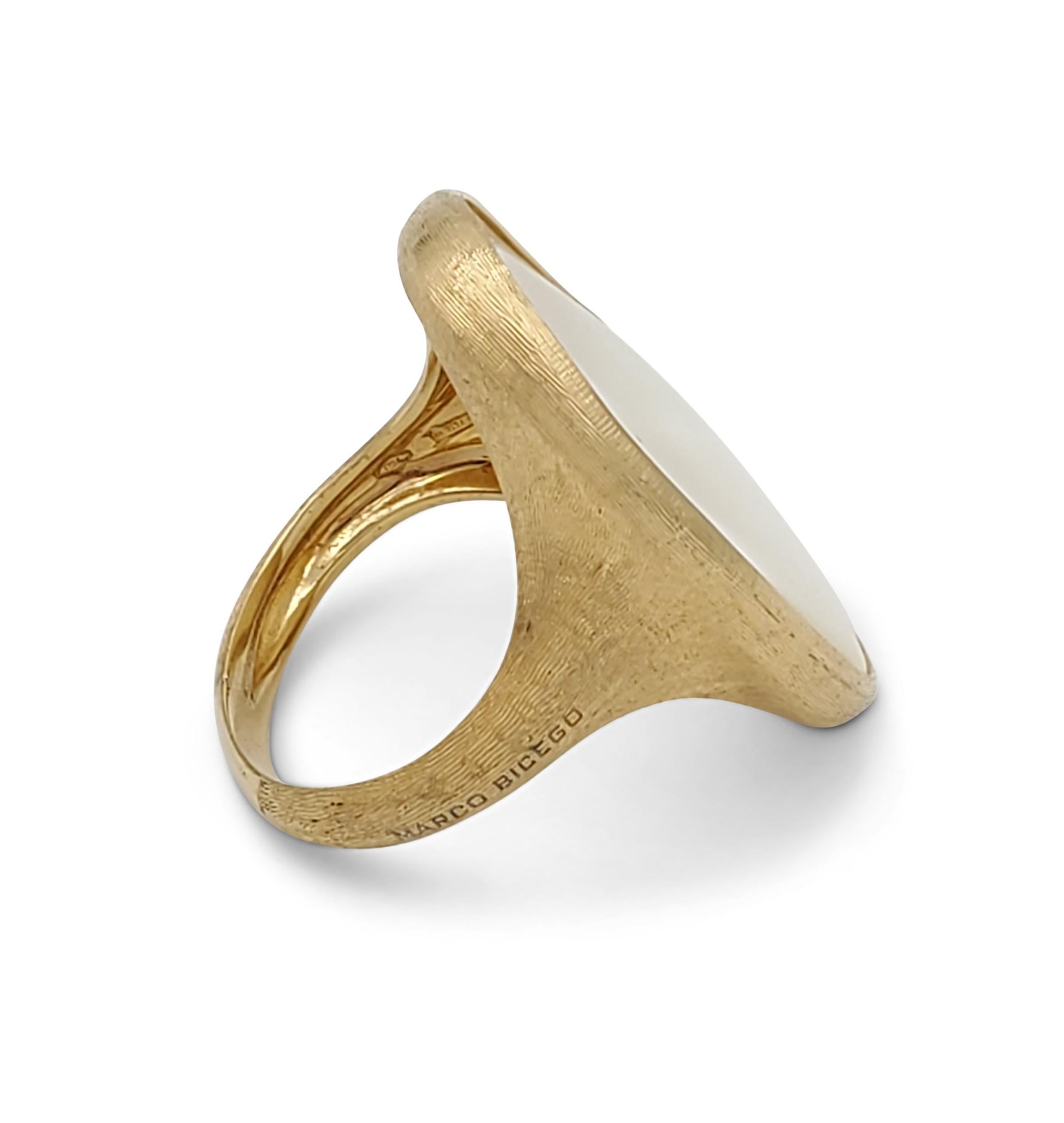 A handcrafted 18 karat yellow gold ring centering on a mother of pearl stone and inspired by the Lunaria flower's petals. Made in Itlay. Signed Marco Bicego and marked 18K, serial no. 2616. Ring size 5. The ring does not come with original box or