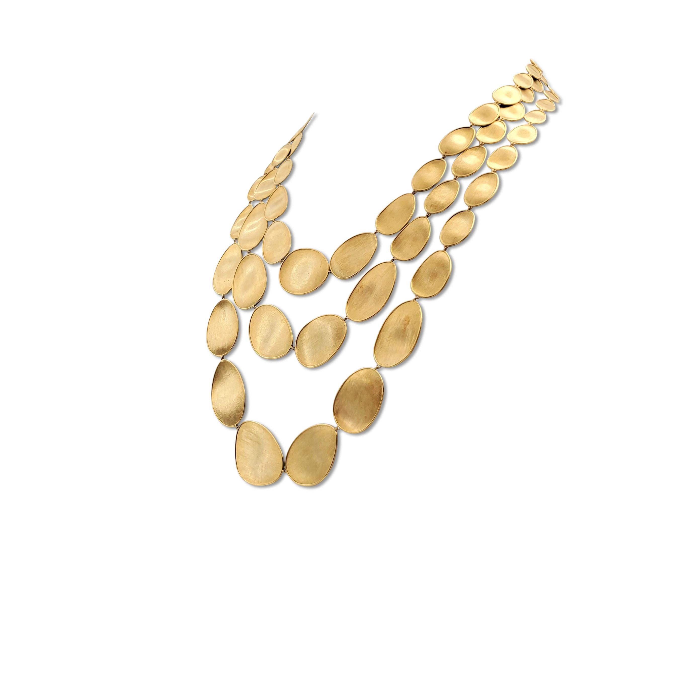 Authentic Marco Bicego 'Lunaria' necklace centers on three 18 karat yellow gold strands of free-form oval-shaped links featuring the house's signature Bulino hand engraving technique, giving the piece a brushed appearance. Signed Marco Bicego, Made