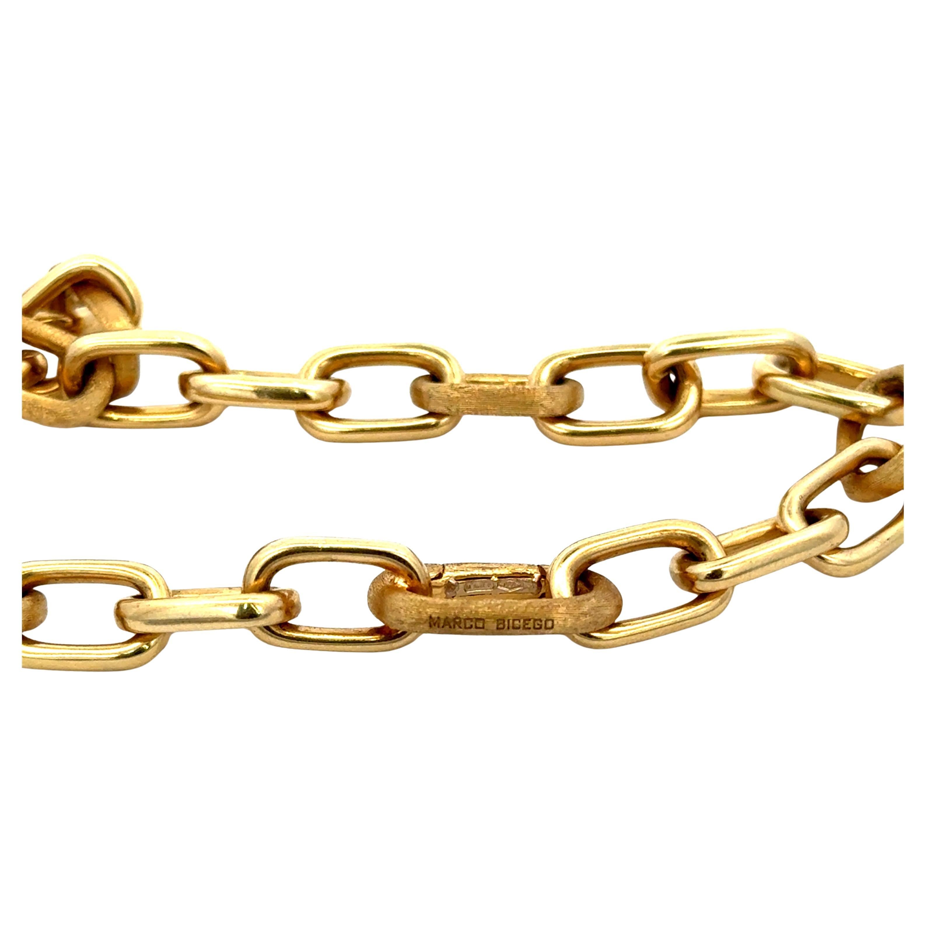 Elegant and timeless, this authentic Marco Bicego necklace and bracelet set is meticulously crafted in 18-karat yellow gold, featuring the designer’s signature hand-engraved satin (brushed) finish.
The piece showcases alternating oval and