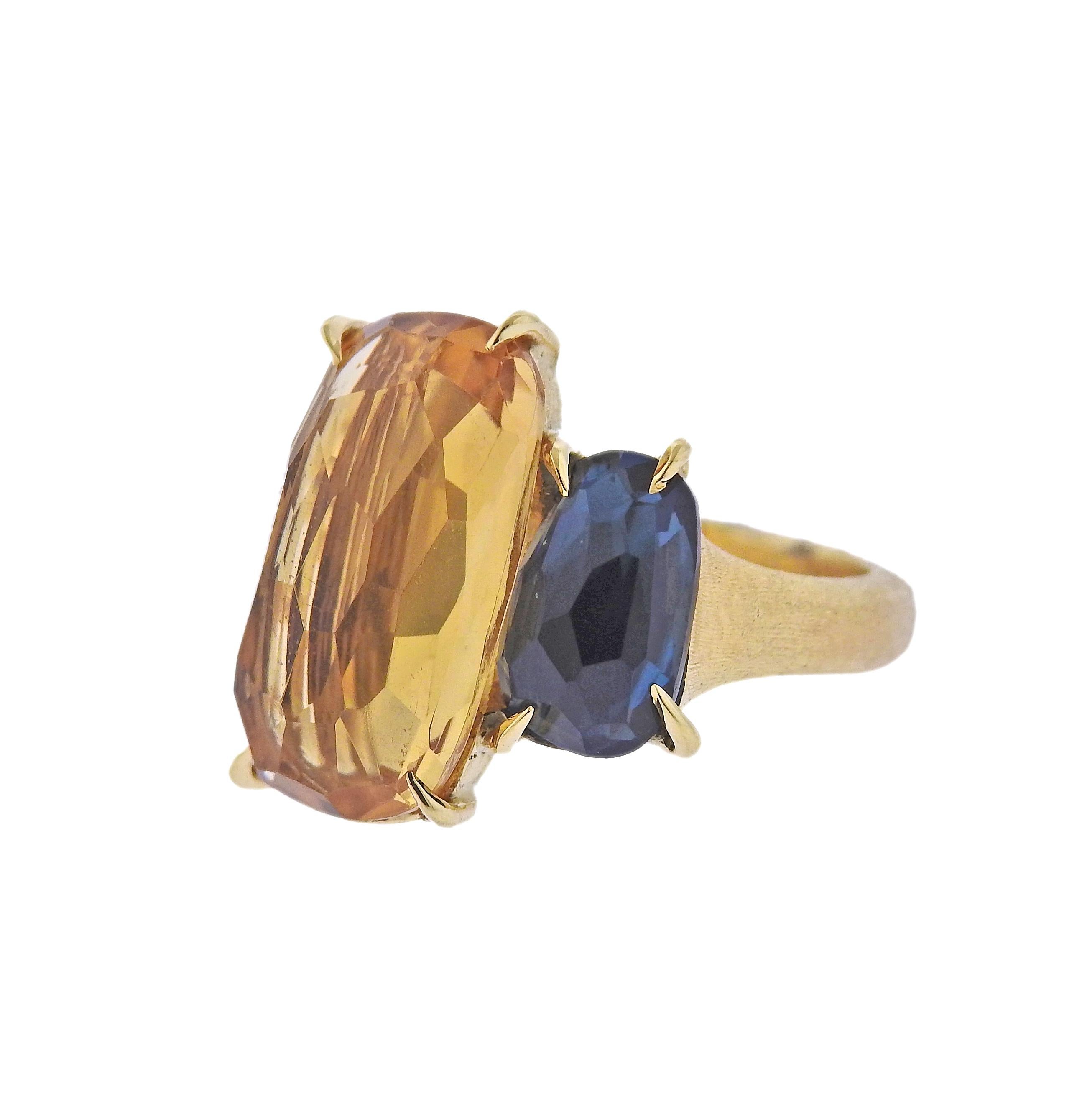 Marco Bicego Murano collection 18K gold ring set with citrine and blue topaz gemstones. Ring measures 26mm x 24mm and available in size 7. Marked: Marco Bicego, Made in Italy, 750. Weight is 8.3 grams.