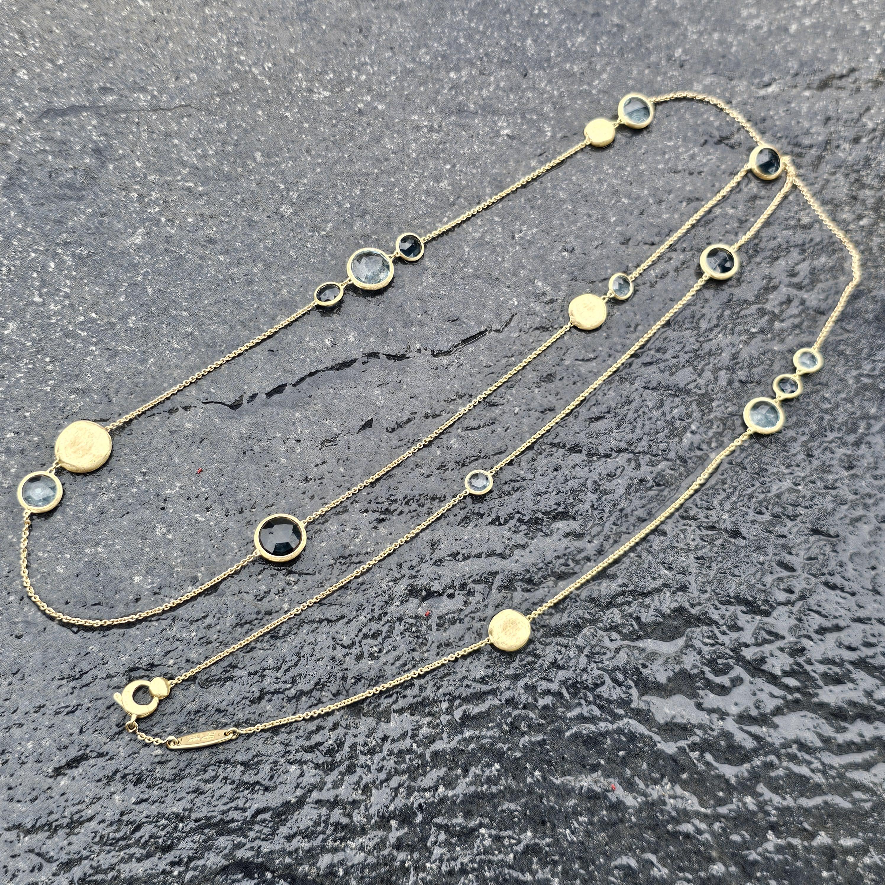 This elegant Marco Bicego necklace is a stunning addition to any jewelry collection. Crafted from 18k yellow gold, the necklace features a delicate chain adorned with topaz stones. The necklace measures 36 inches in length and features a secure