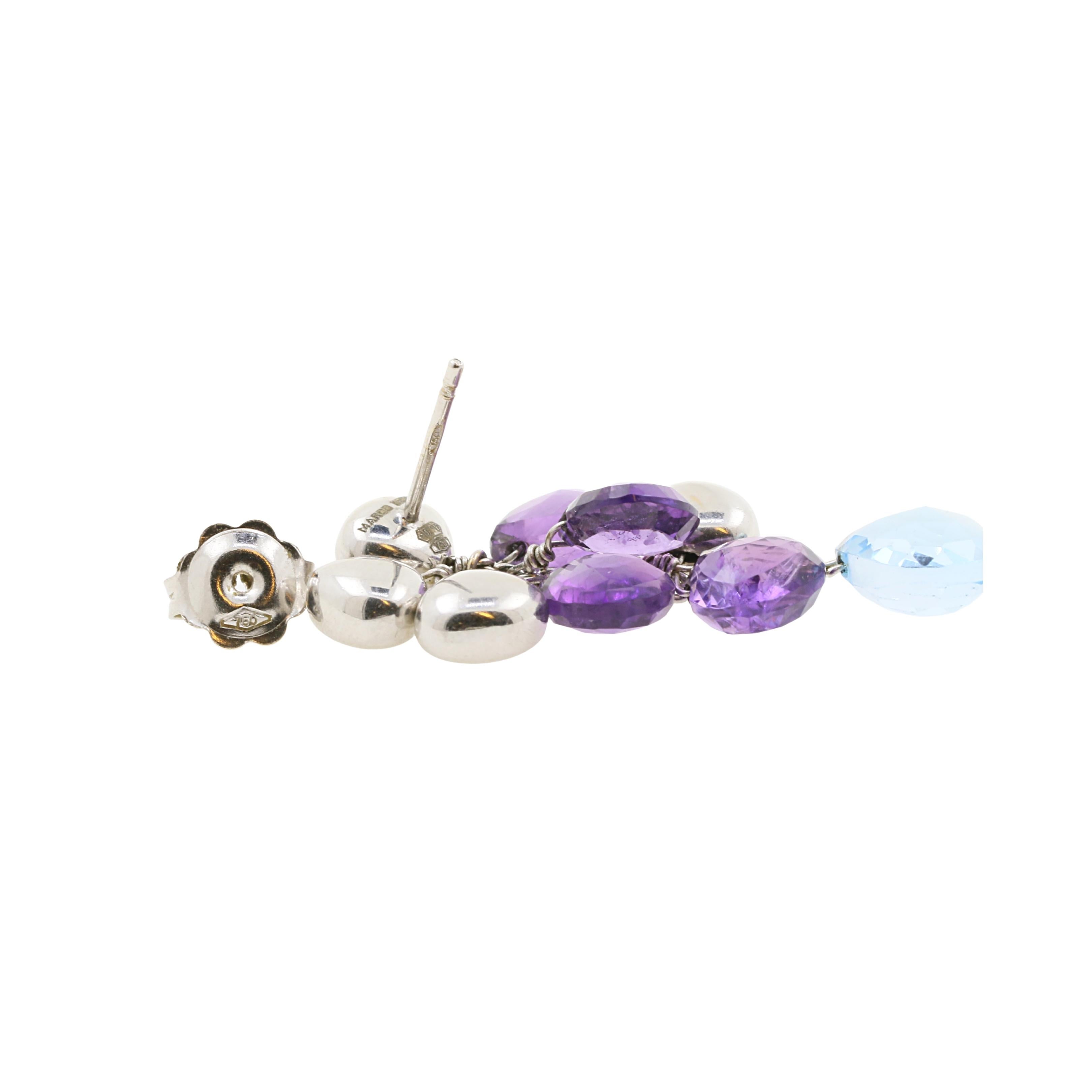 From the iconic Paradise collection from Marco Bicego, a pair of earrings in white gold, amethysts and aquamarines, duly signed. 
Each earring is composed of 4 heart-shape elements , 4 amethysts and 1 aquamarine to finish the style..
Stamps: 750 and