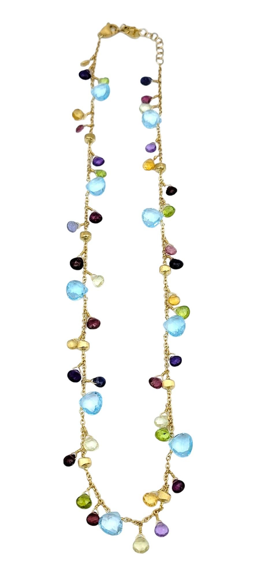 This gorgeous Marco Bicego Paradise multi-colored gemstone necklace features vibrant briolette-cut stones set in 18 karat yellow gold. Each stone, ranging in hues from deep blues and greens to vivid pinks and purples, adds a pop of color and
