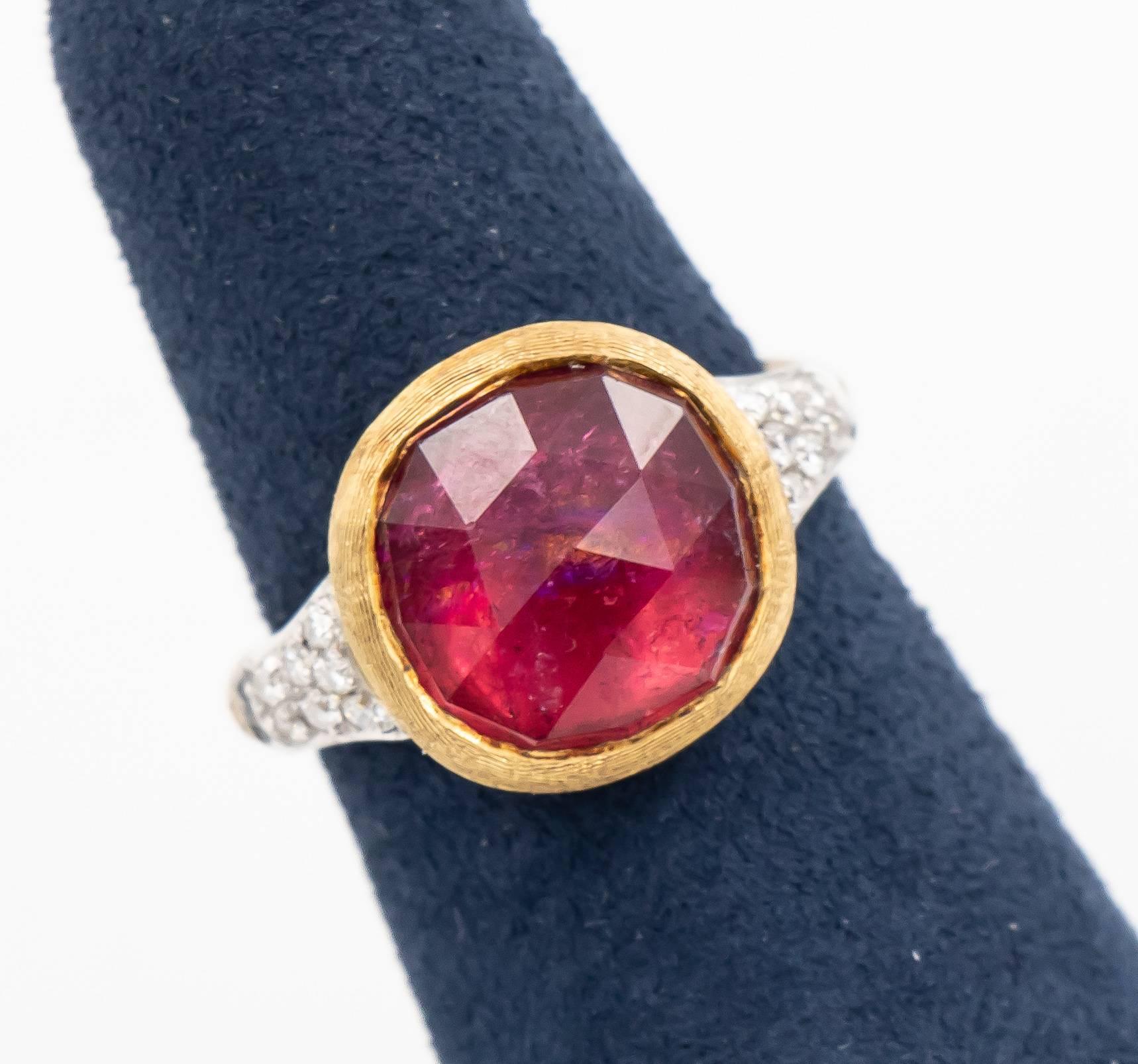 This Marco Bicego ring has a beautiful pink tourmaline center stone.  The center pink tourmaline has a pretty facet configuration and has inclusions which certainly matches the Jaipur style.  There are 7 round brilliant cut diamonds on each side of