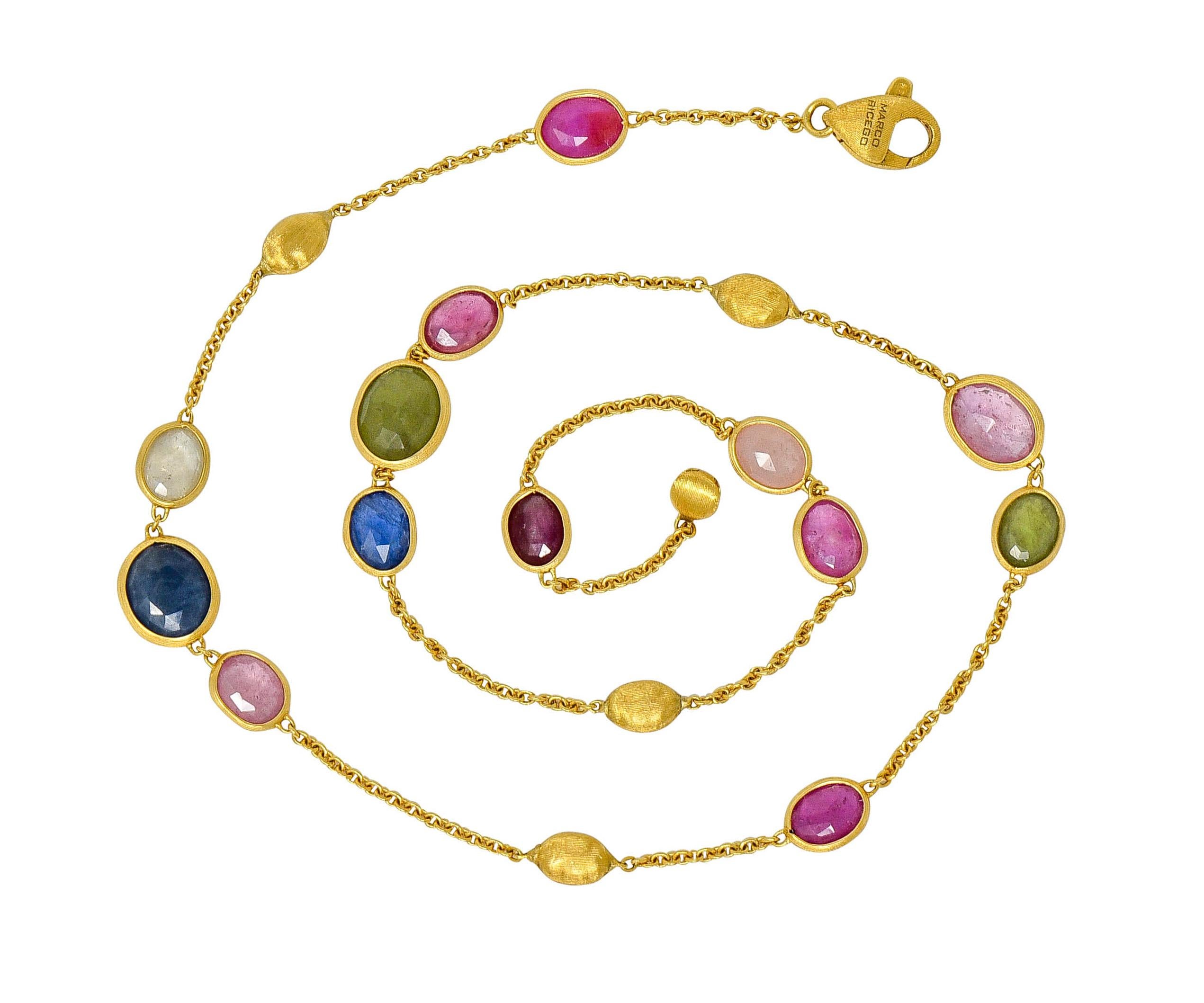Necklace is designed with brushed gold oval stations alternating with gemstones, bezel set in brushed gold surrounds

Featuring pink, green, blue, and clear sapphire, faceted on both sides, translucent with natural inclusions

Completed by cable