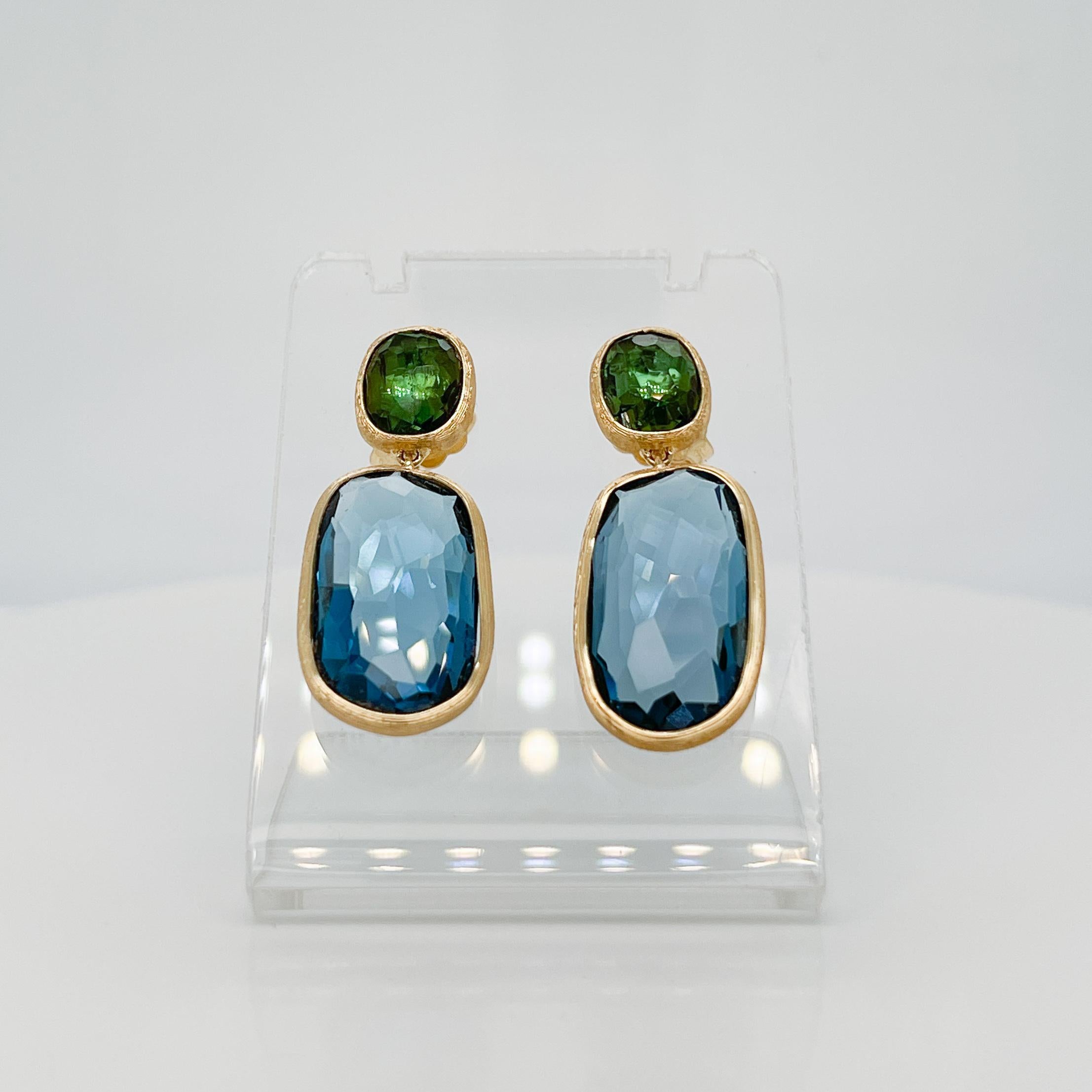 A fine pair of 18 karat gold, topaz & tourmaline earrings. 

By Marco Bicego.

From the Siviglia collection.

In 18k gold with bezel-set faceted green tourmalines and blue topaz drops.

Simply a wonderful pair of earrings from one of Italy's best