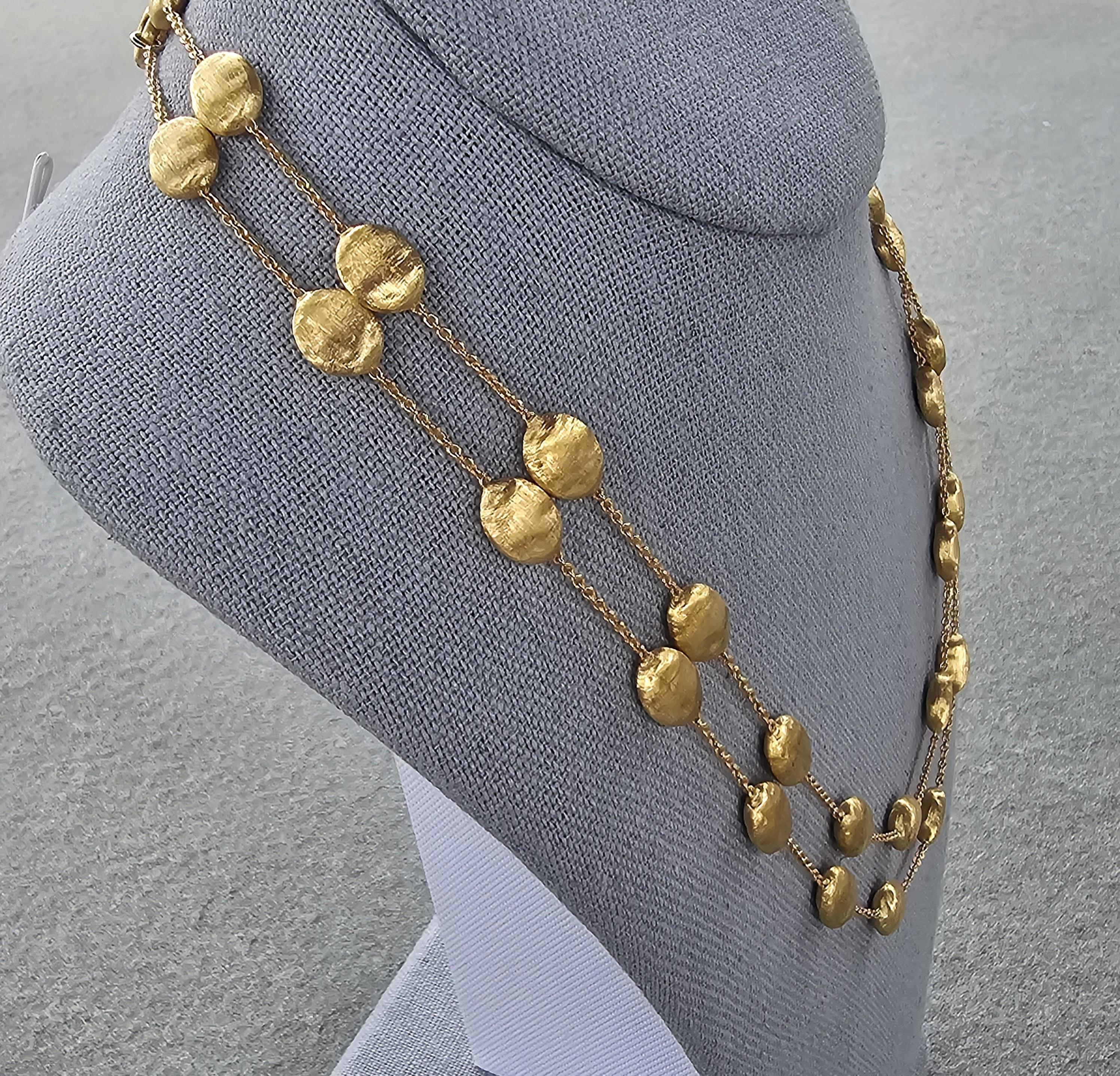 Enhance your collection with this exquisite Marco Bicego chain necklace. Crafted from luxurious 18k gold, this piece features a series of textured gold beads evenly spaced along a delicate 36-inch chain. The subtle elegance of the design makes it a