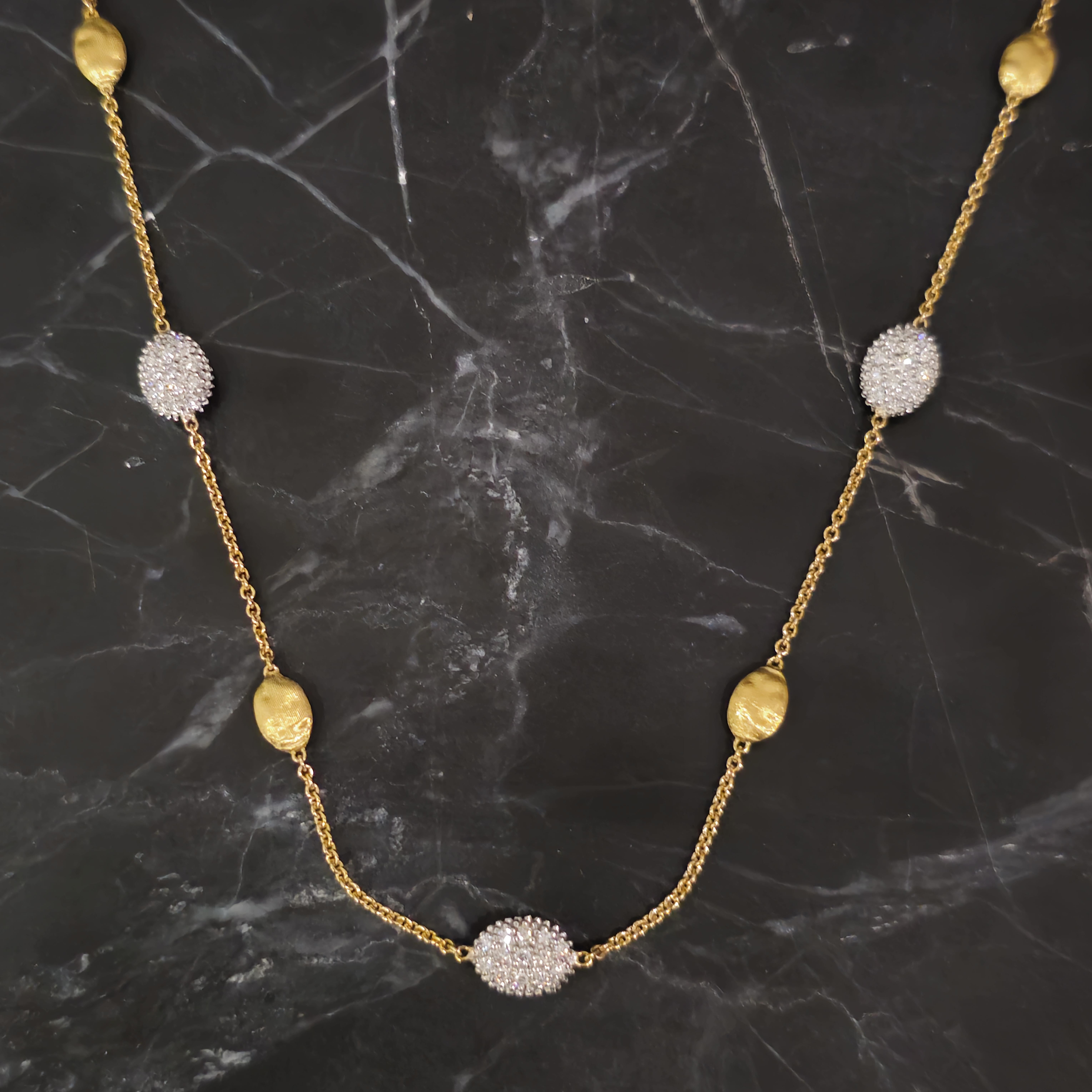 Enhance your jewelry collection with this exquisite Marco Bicego chain necklace. Crafted from 18k yellow gold, this piece features elegant diamond accents with a total carat weight of 0.75, adding a touch of sophistication. The necklace showcases a