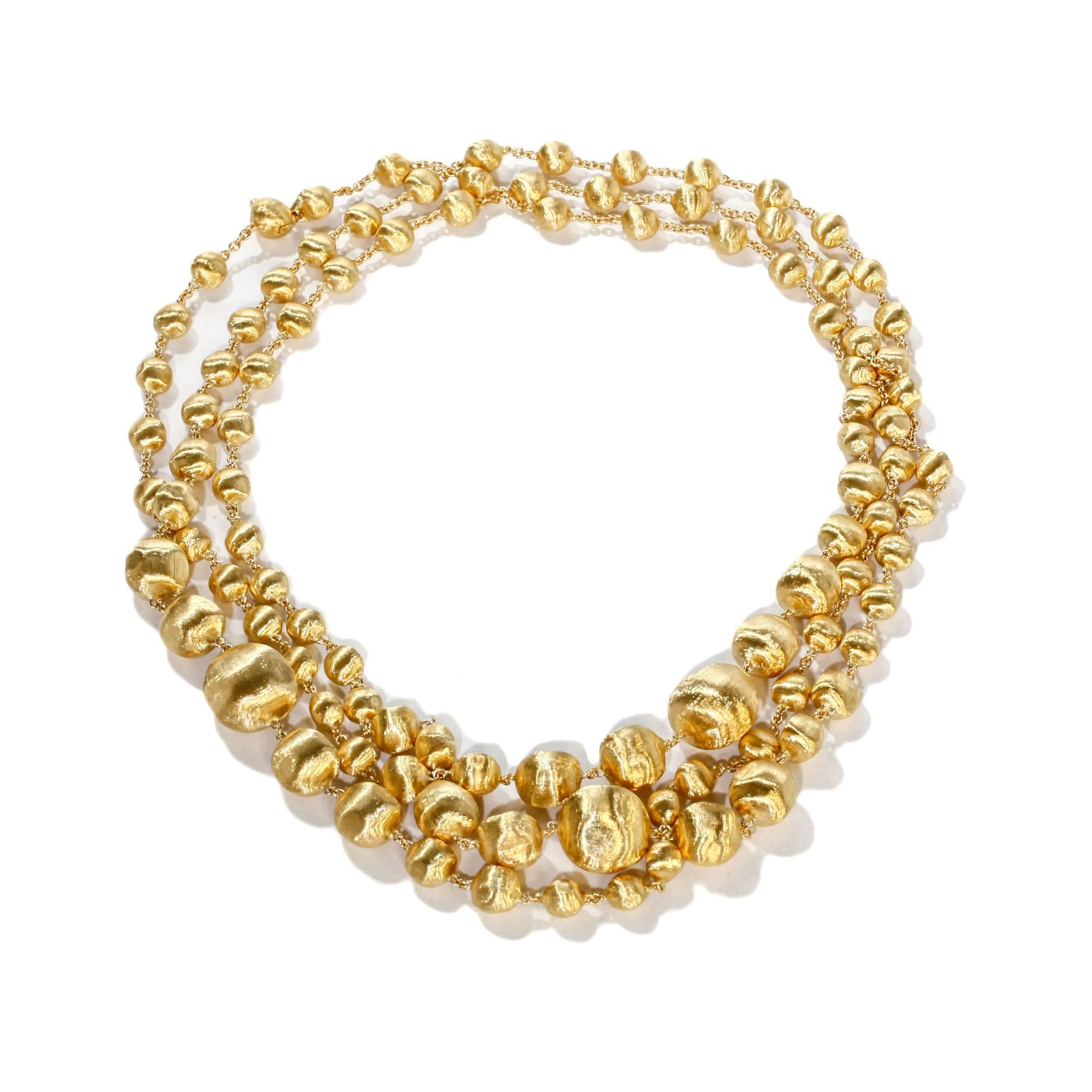 This 18k yellow gold Marco Bicego necklace from the Africa collection is inspired by tribal jewelry and the soft dunes of the Sahara. It was hand engraved by Italian artisans. The necklace measures 47 inches in length and can be doubled or tripled