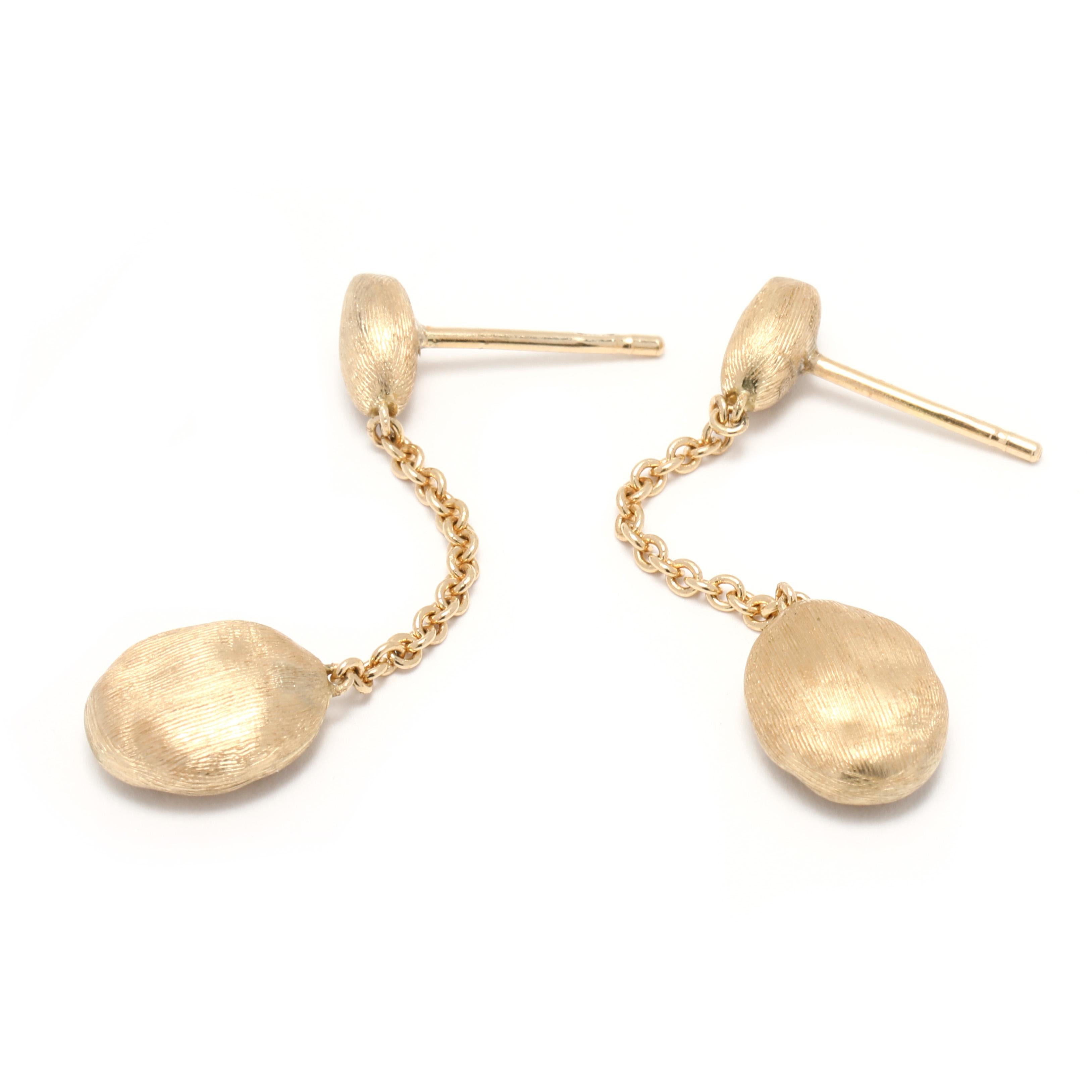 These Marco Bieco Siviglia Dangle earrings are perfect for everyday wear. They are crafted from 18K yellow gold and have a length of 1.25 inches. The brushed gold finish adds a subtle shimmer for a classic and timeless look. These earrings will make