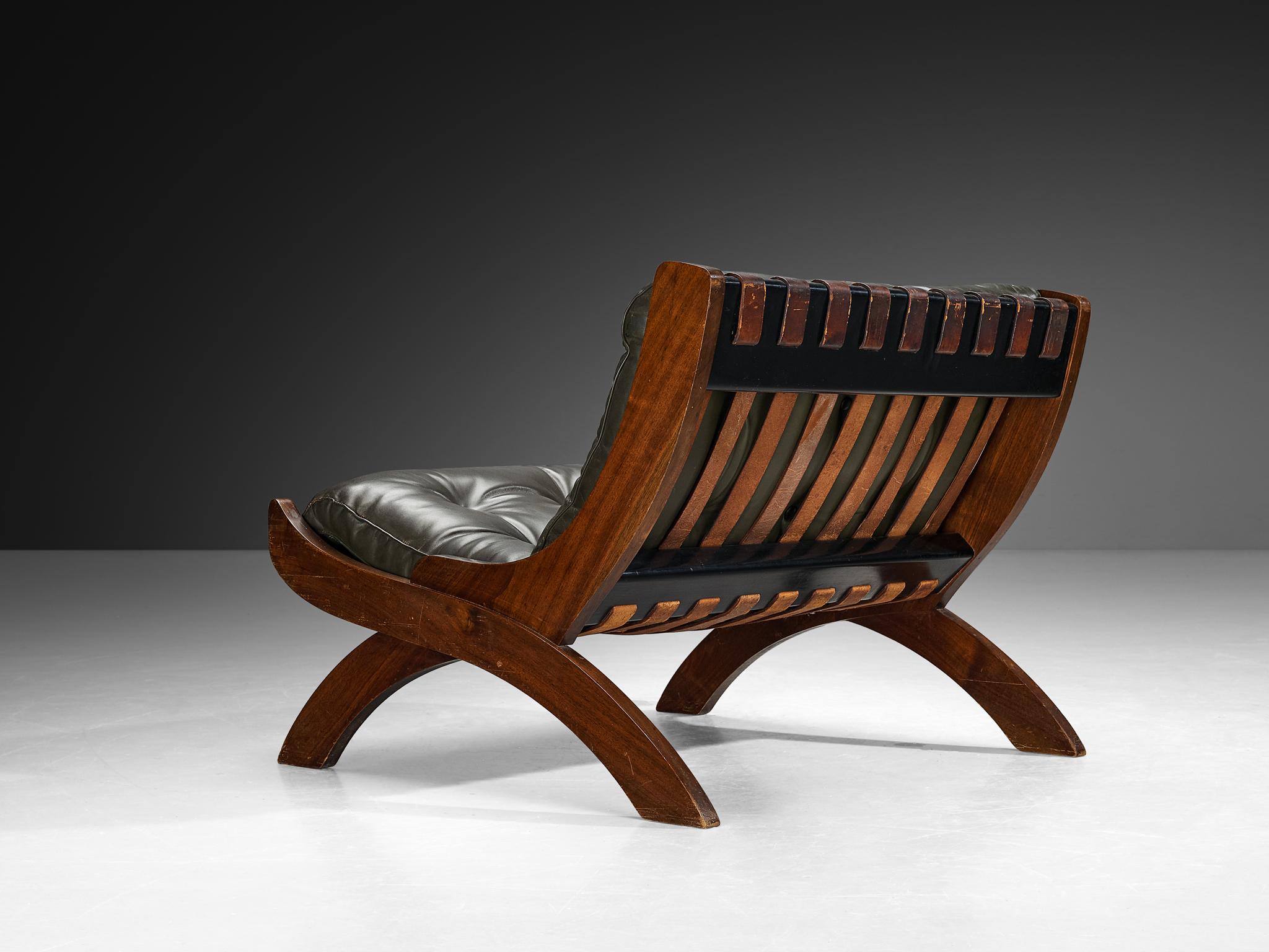 Marco Comolli for I.C.F. De Padova, lounge chair, lacquered wood, walnut, leather, Italy, 1965. 

A design by Marco Comolli, strong, sincere, and elegant, the friendly curved framework takes center stage. The seat and backrest follow a reclined