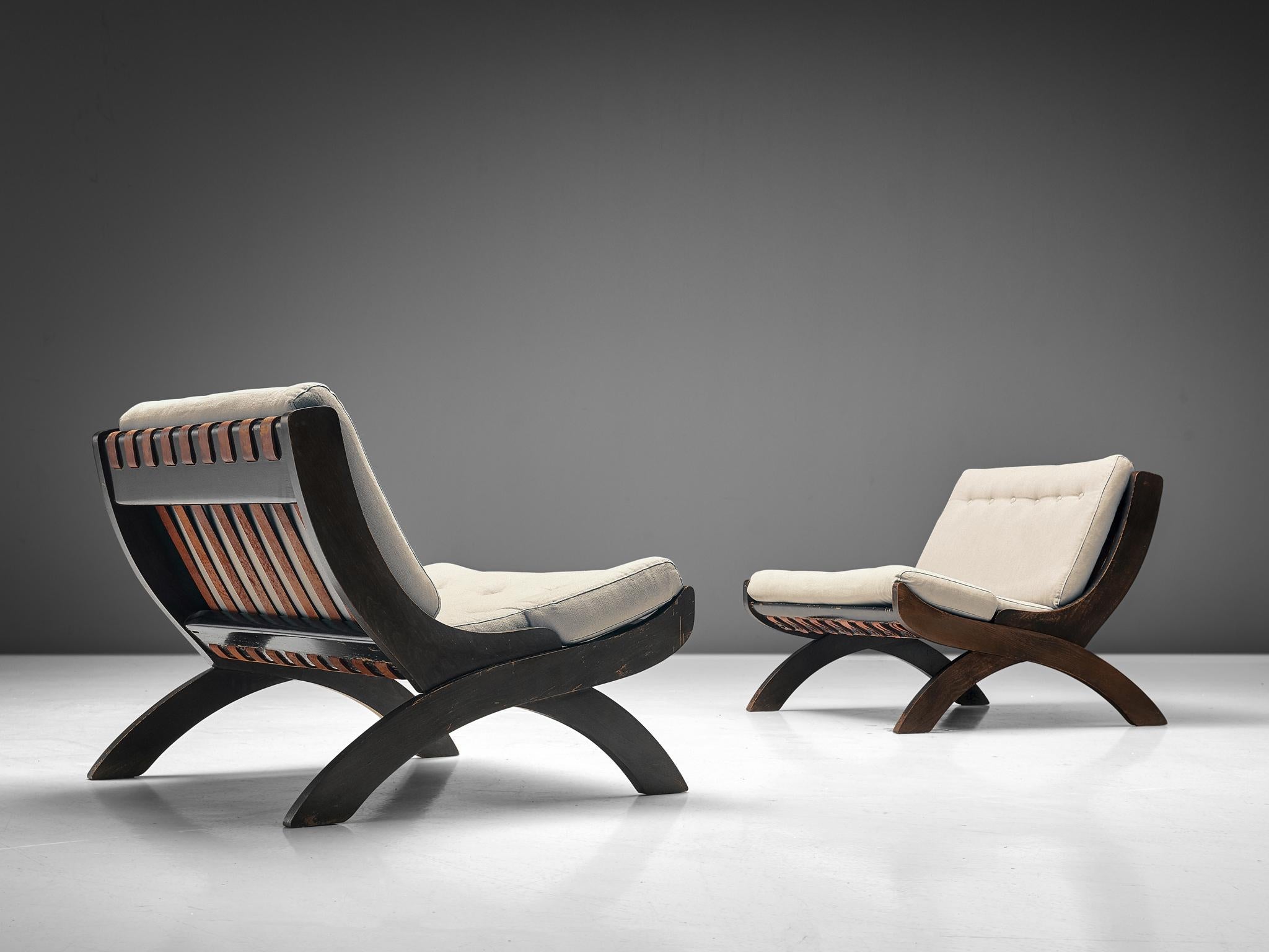 M. Comolli for I.C.F. De Padova, pair of 'CP1' pair of lounge chairs, walnut, leather, fabric Kvadrat - 65 0100, Italy, 1965. 

This pair of two sturdy lounge chairs shows a beautiful combination of materials. The back shows cognac leather straps