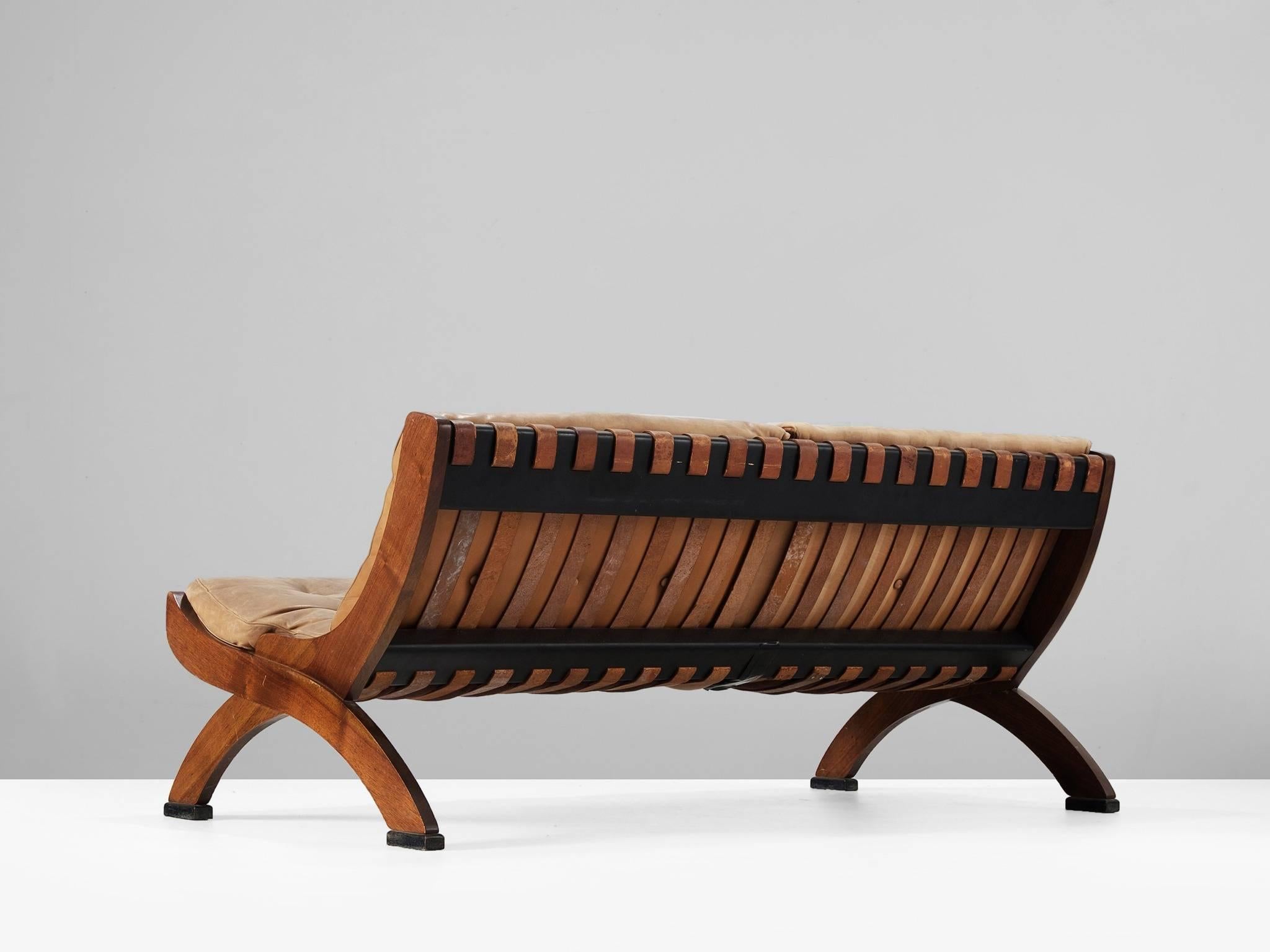 Marco Comolli for I.C.F. De Padova, settee, in walnut and leather, by Italy, 1960s. 

This wonderfully aged sofa has a beautiful all-over patina. Highly comfortable due to down filling and well-designed proportions. The back shows nice cognac
