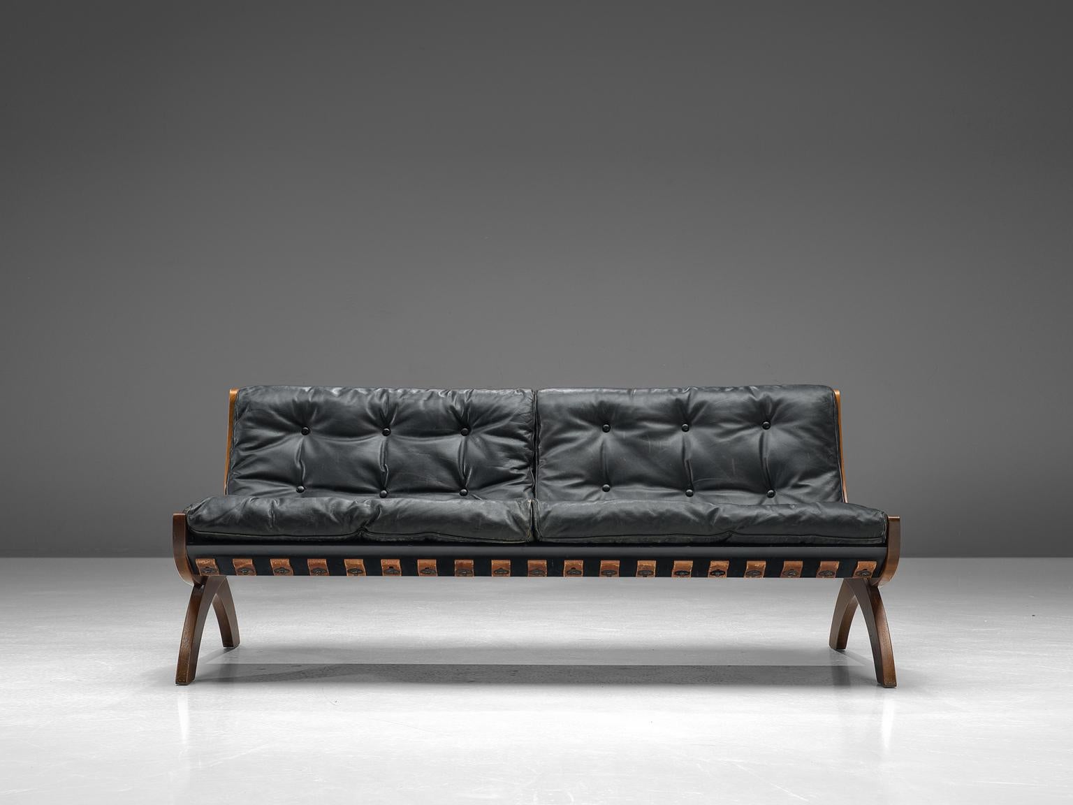 Marco Comolli for I.C.F. De Padova, settee, walnut and leather, Italy, 1960s. 

Highly comfortable sofa due to dawn filling and well-designed proportions. The back shows nice cognac leather straps that supports the back and seat cushions, which is