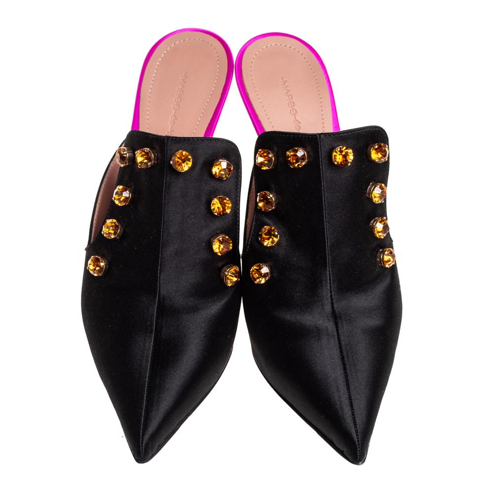 A stylish pair of mules by Marco de Vincenzo will make heads turn your way wherever you go. These black shoes have been crafted in Italy and made from quality satin. They are styled with pointed toes, crystal stud detailing, 11 cm heels and
