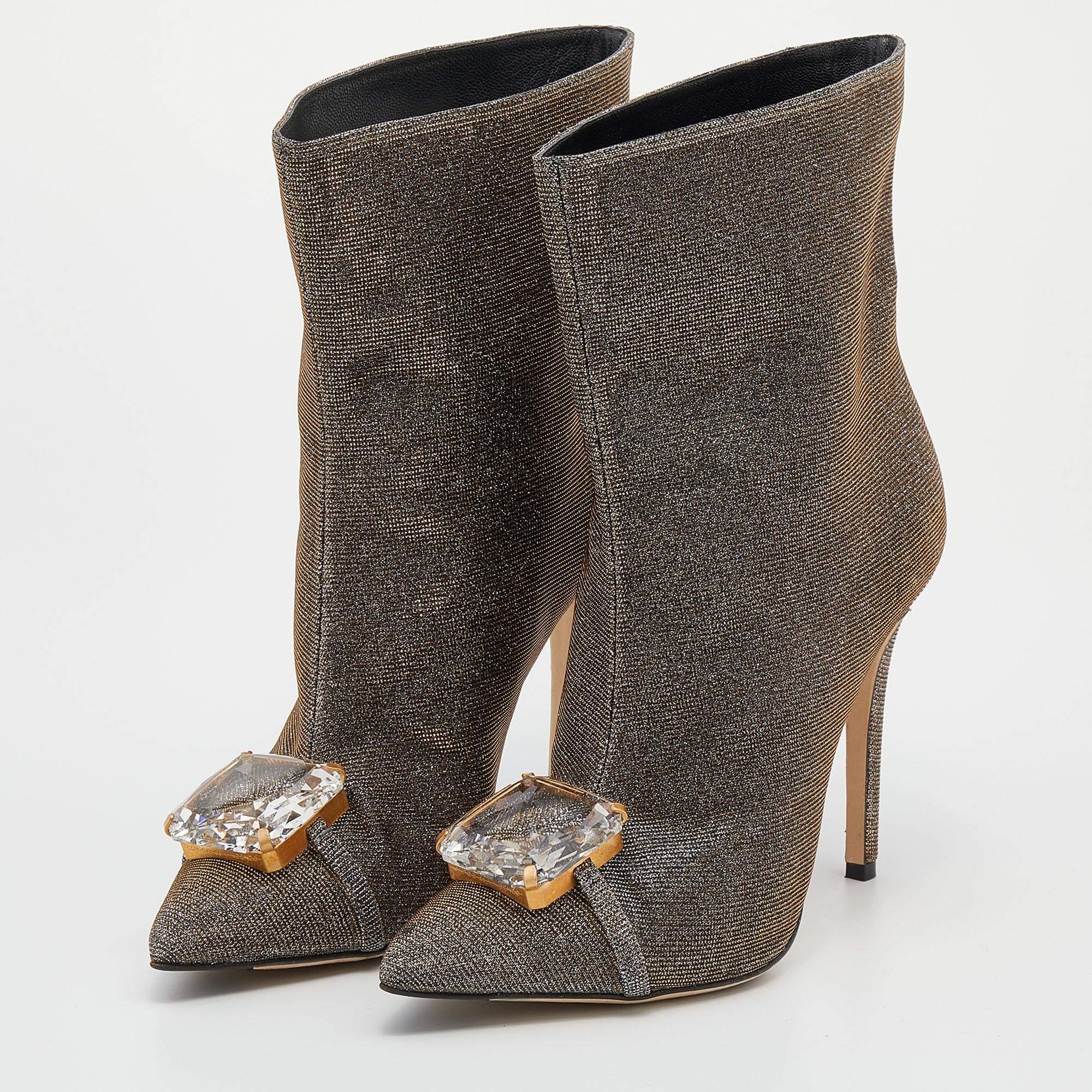 The crystal embellishment on the front elevates the silhouette of these Marco De Vincenzo boots. Created from metallic lurex fabric, they exhibit gold-tone hardware, 11.5cm heels, and a slip-on fitting.

