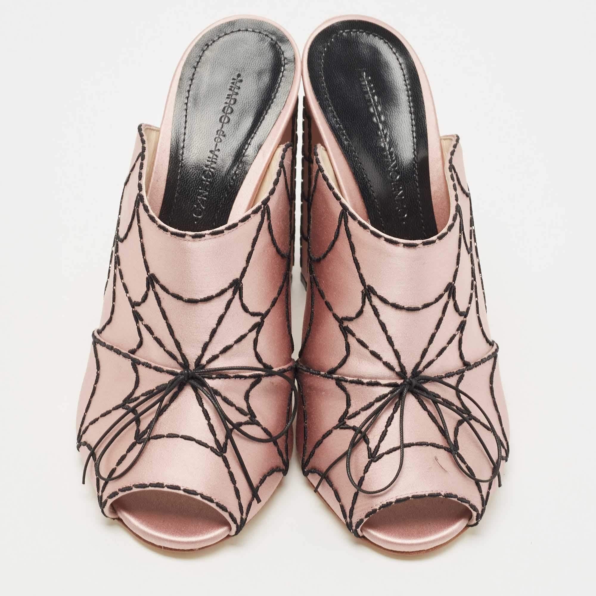 The Marco de Vincenzo mules are a luxurious and eye-catching footwear choice. Crafted from smooth pink satin, these mules feature exquisite spider web embroidery, adding a touch of intrigue and elegance. With a comfortable slip-on design and a sleek