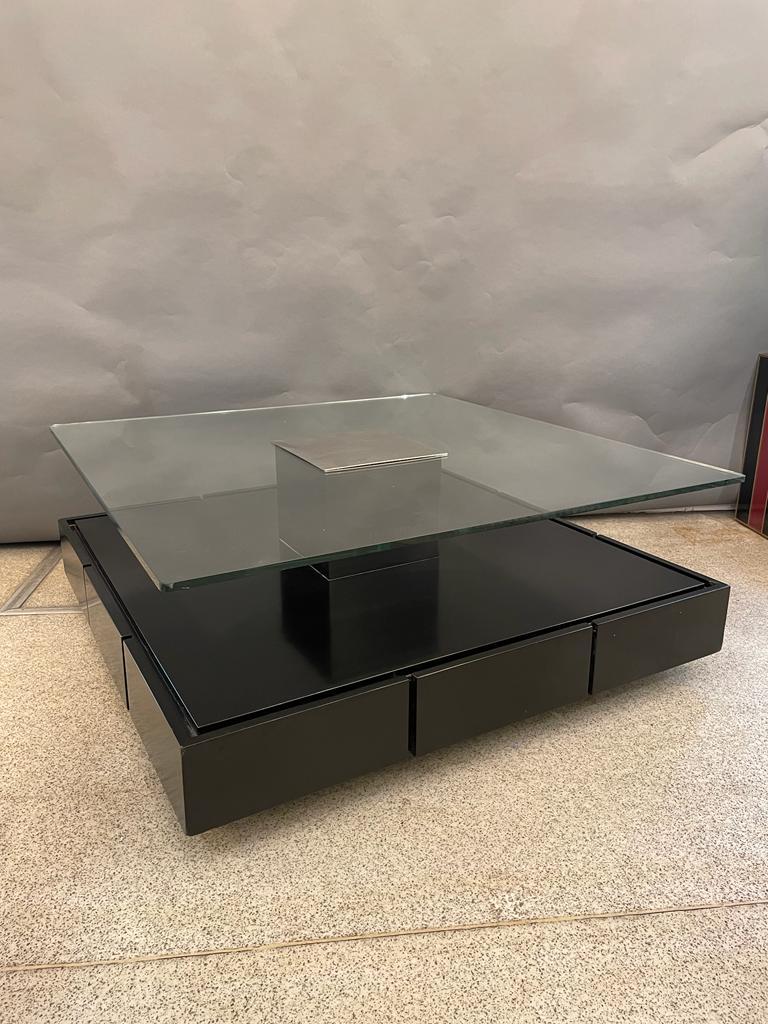 Minimalistic cocktail table by Italian designer Marco Fantoni for Tecno, Milano. This coffee table with clean and modern design consist of a raised base in wood, with satin finish in deep dark brown or black. The square base is covered with