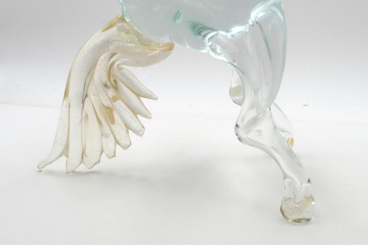 A spectacular clear glass horse sculpture of Murano glass, with gold flecks
bright and clean glass, stands on its feet.